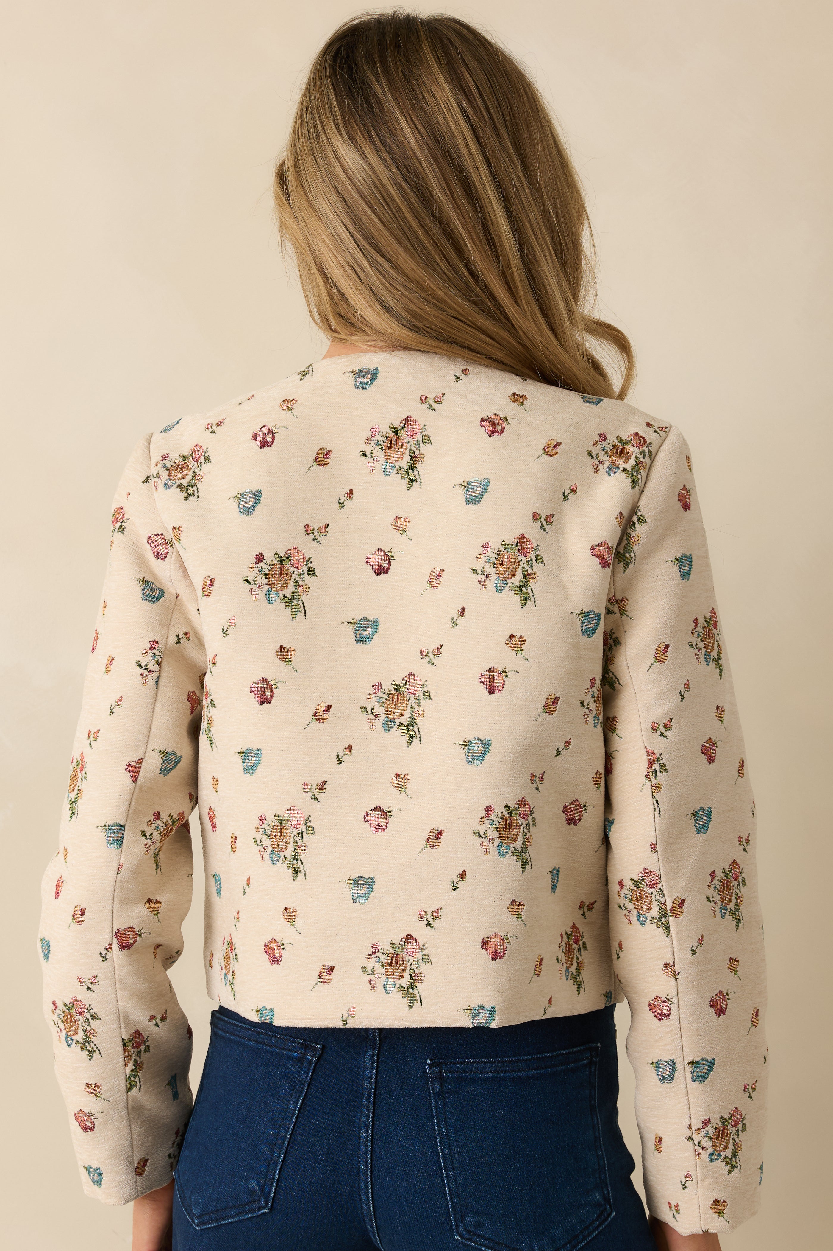 Rear view of the cream floral tapestry jacket showing the structured cropped design and smooth tailored finish.