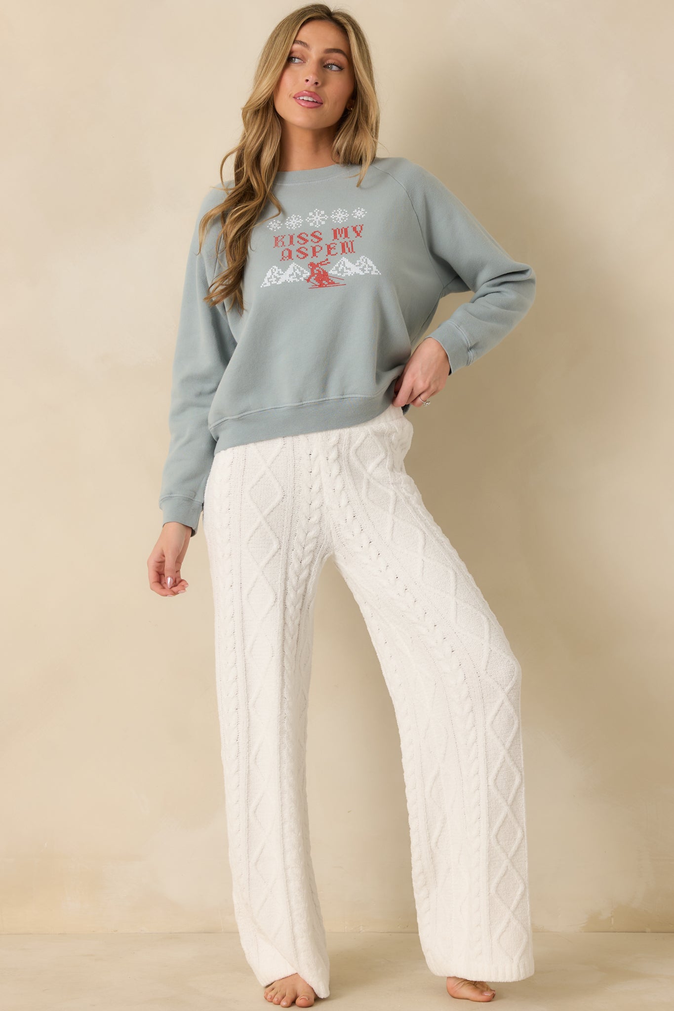 Crewneck sweatshirt in slate blue highlighting raglan sleeves and ribbed trim details.