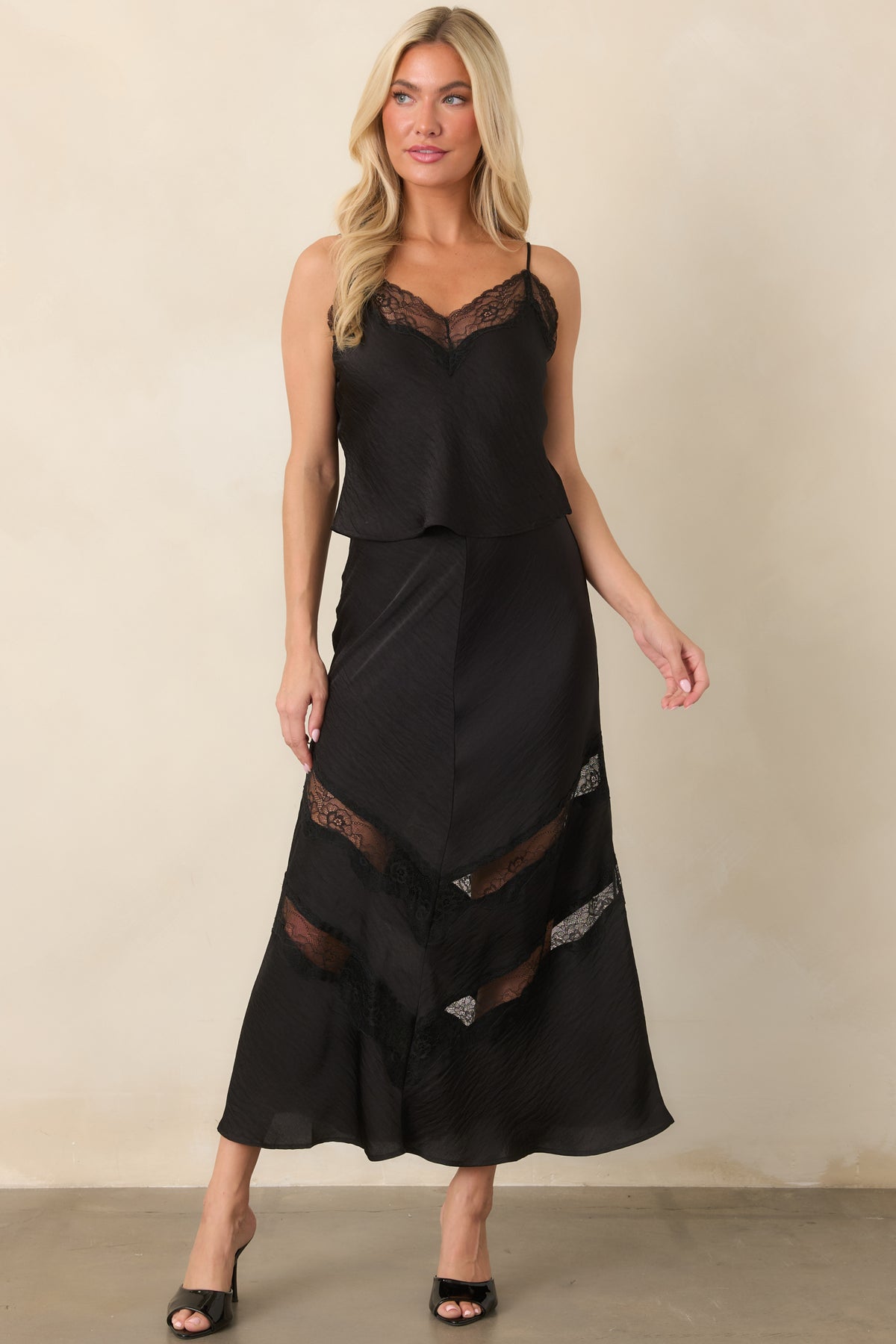 Crinkled satin skirt showcasing a sleek fitted waist and fluid bias-inspired silhouette that falls to a midi length.