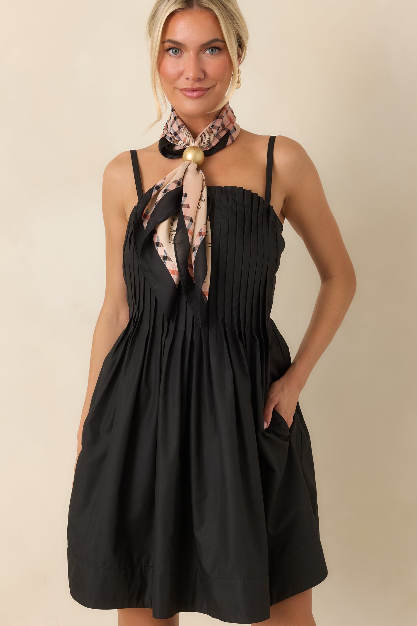 Close-up highlighting the crisp pleating and lightweight woven fabric texture of the mini dress.