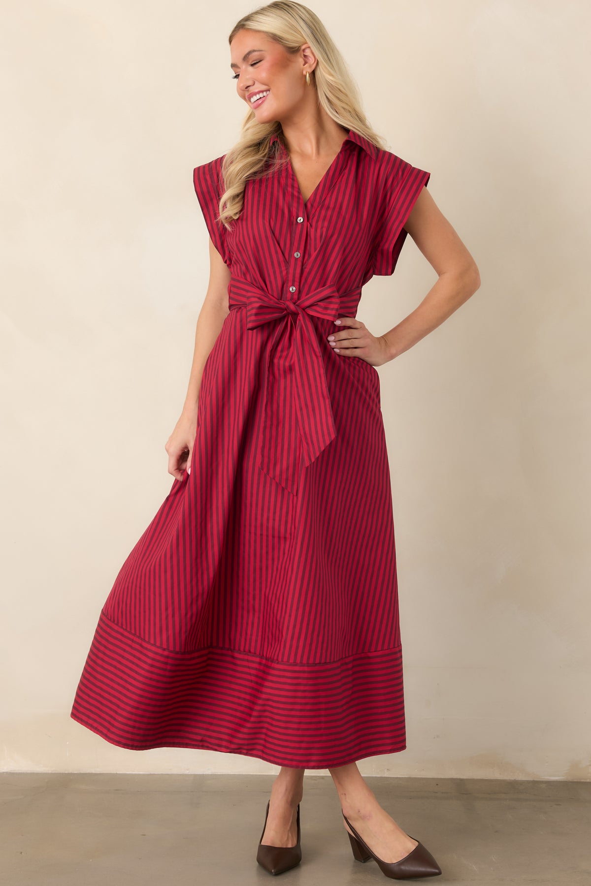 Red and burgundy vertical striped midi dress with cap sleeves, a tie waist and horizontal stripe detailing at the hem.