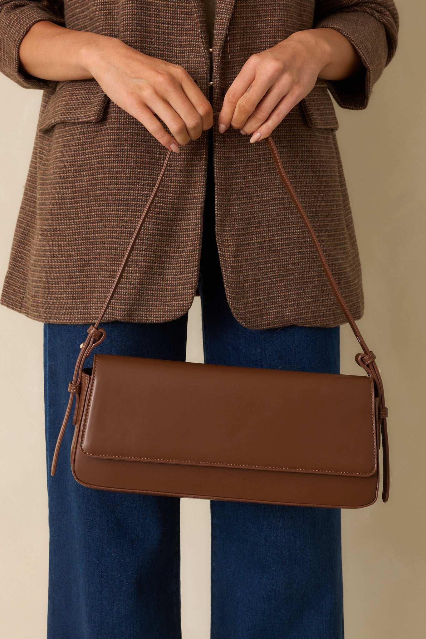 Midsection crop emphasizing the structured baguette shape and clean brown finish.