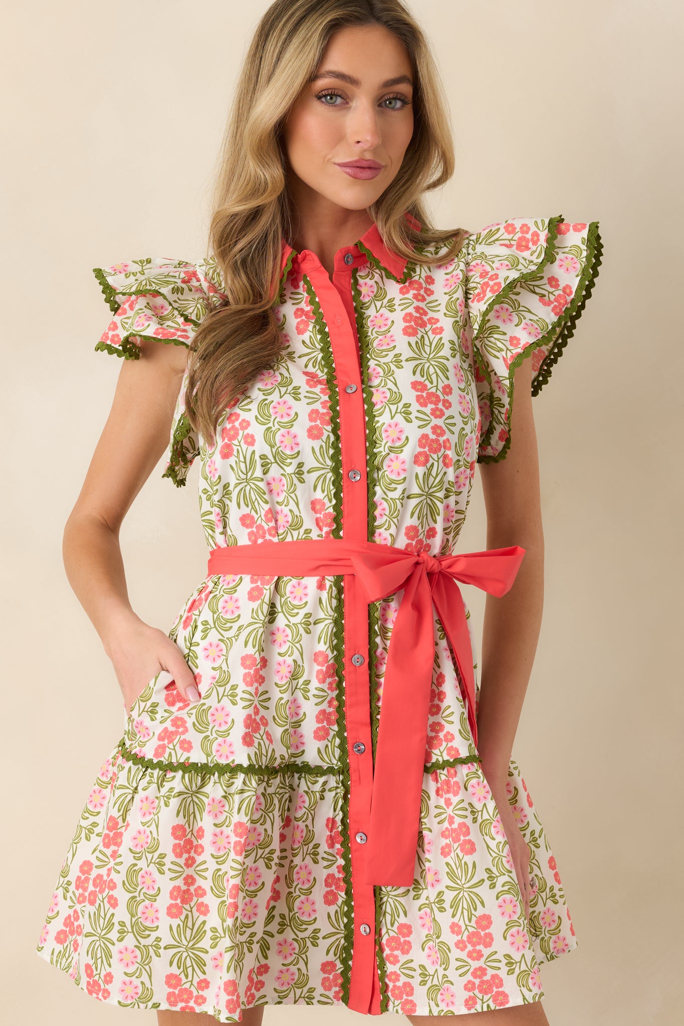 Midsection crop highlighting the button-front closure and decorative green ric rac detailing.