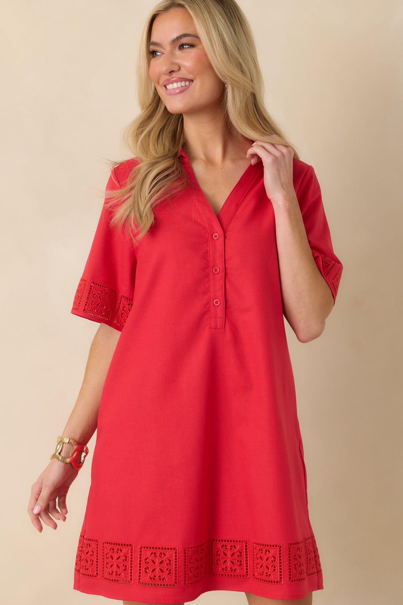 Detail crop highlighting the decorative cutout detailing along the sleeve cuffs.