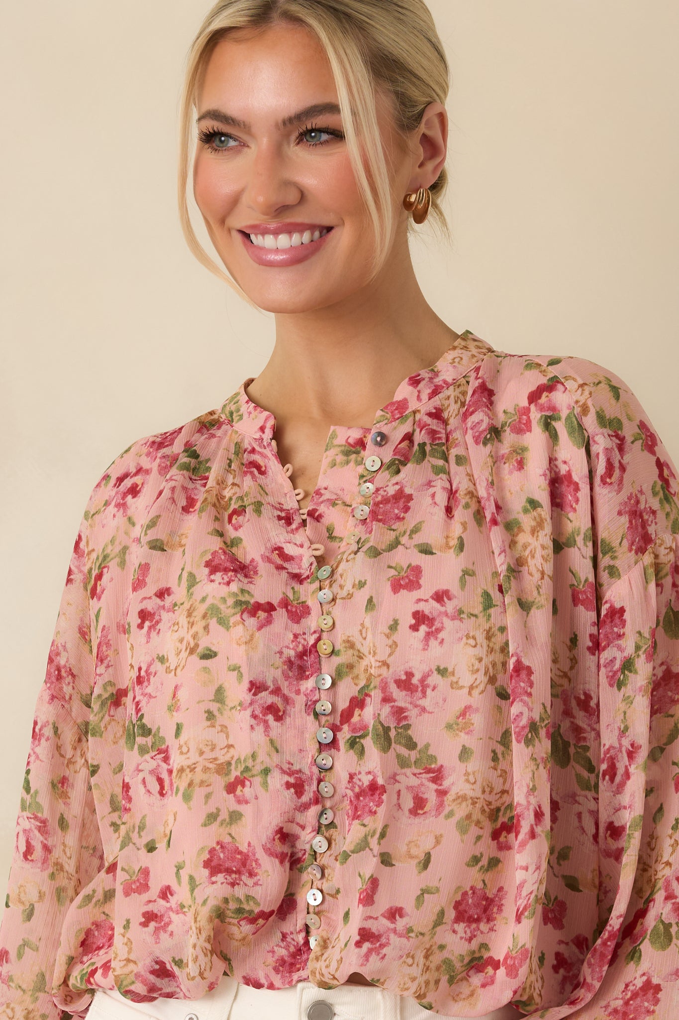 Midsection crop highlighting the elasticized waist and gently ballooned silhouette of the blouse.