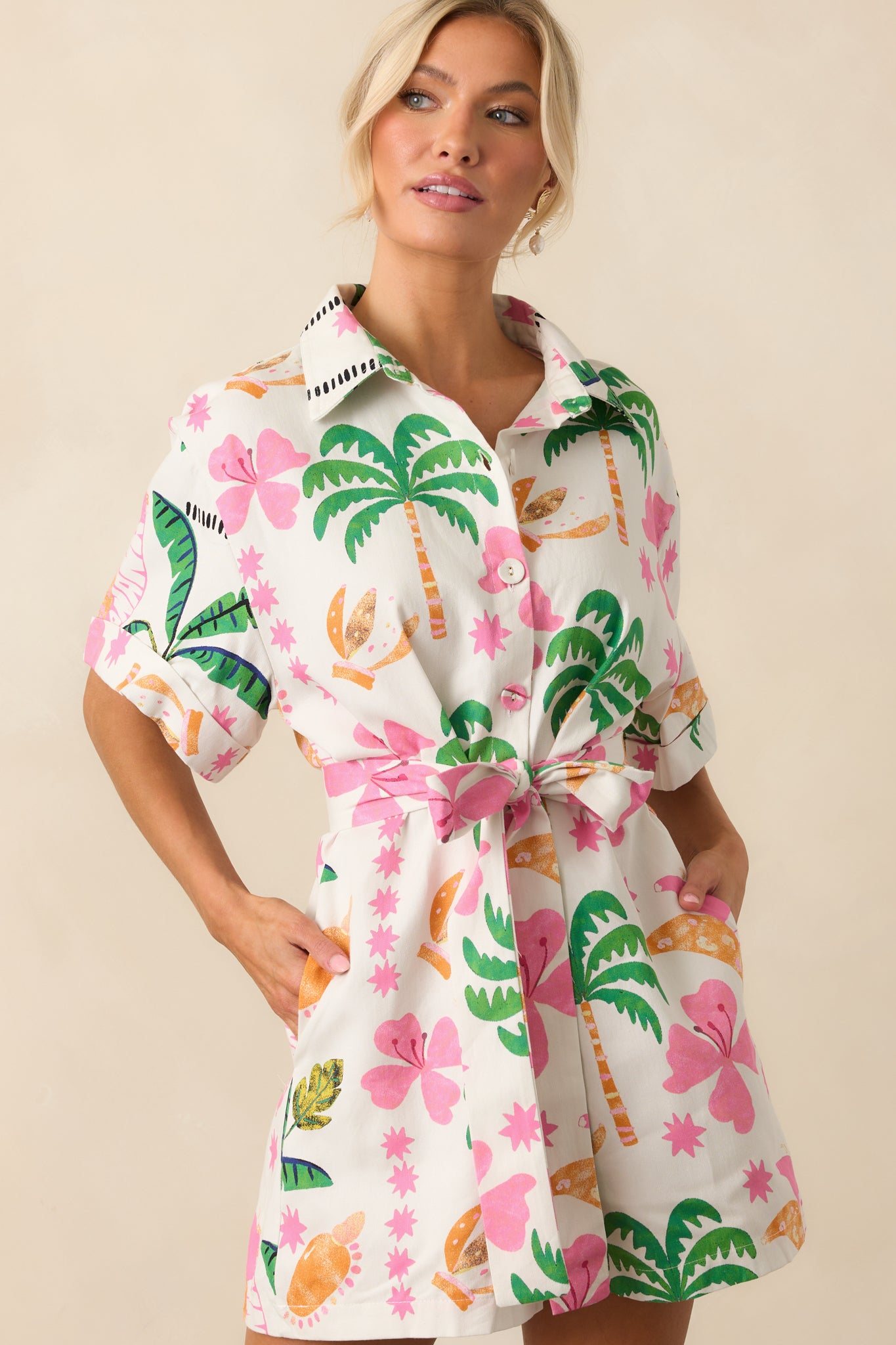 Focused crop of the waist and hip area showing the tropical print, belted waist, and the functional pockets.