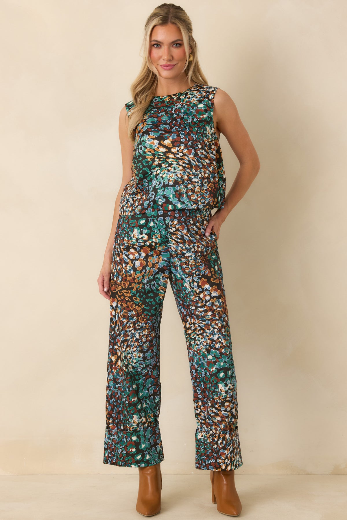 Cropped printed pants featuring a high-rise waist and fabric-covered button closure.
