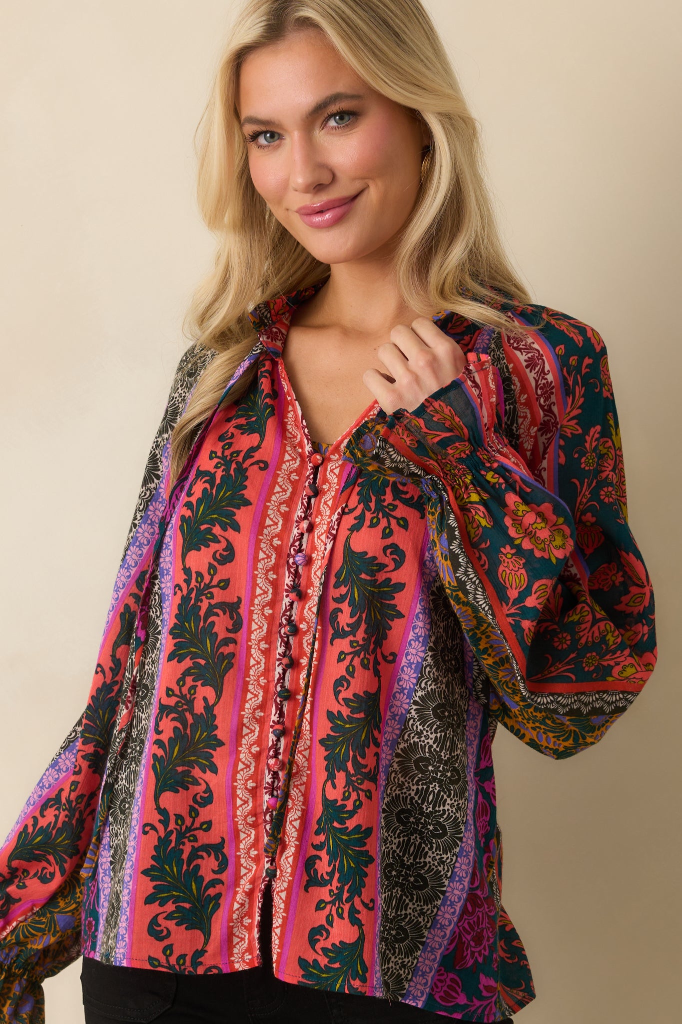 A cropped angled front view showing the long sleeves with elastic cuffs.