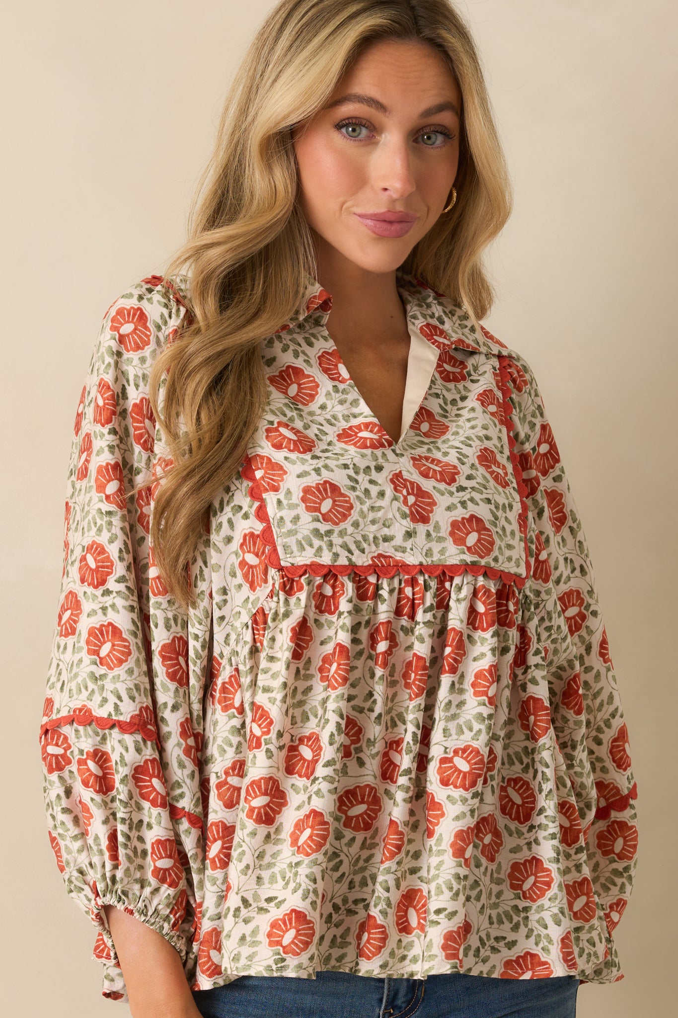 A cropped angled shot focusing on the floral print fabric and long sleeves with elastic cuffs.