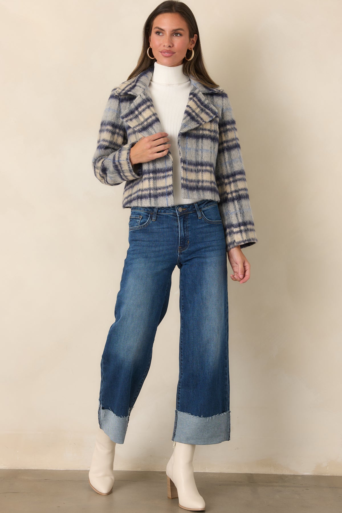 Cropped blue, navy, and ivory plaid jacket with oversized notched lapels, relaxed sleeves, and wide cuffs.