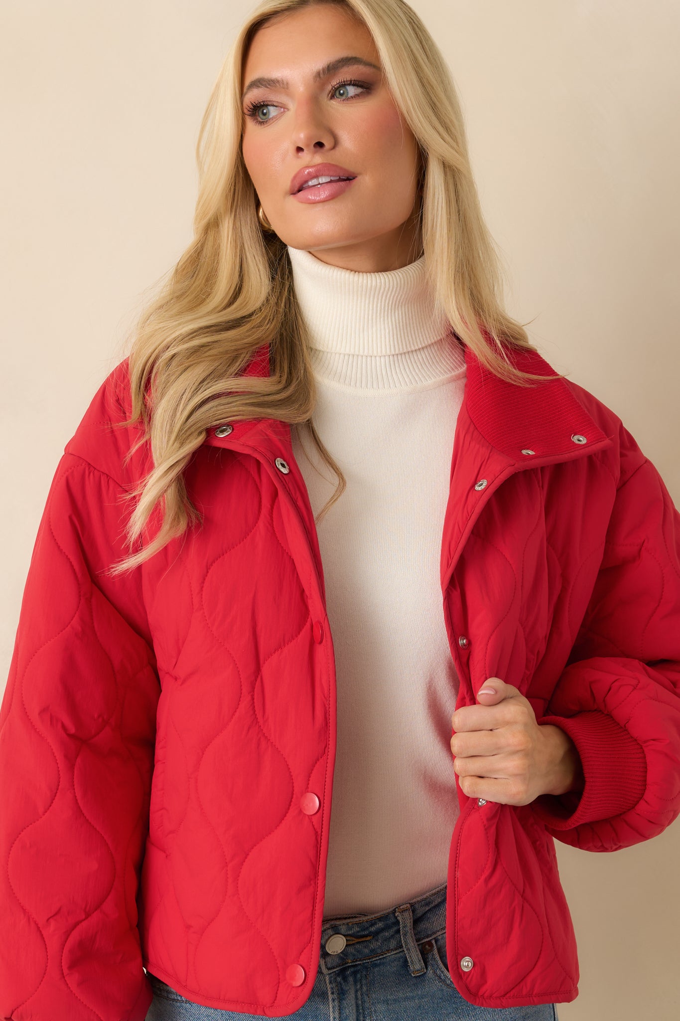 Cropped close-up showing the padded construction and stitched quilt pattern across the front panel.