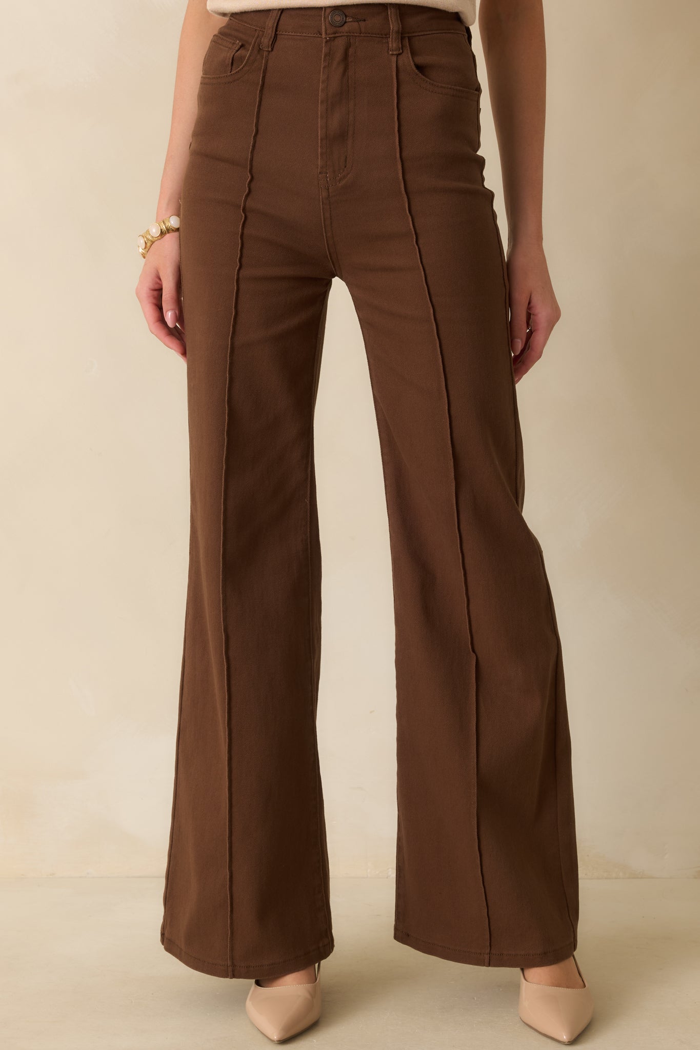 A cropped close view showing the smooth fabric texture and wide-leg flare from waist to thigh.