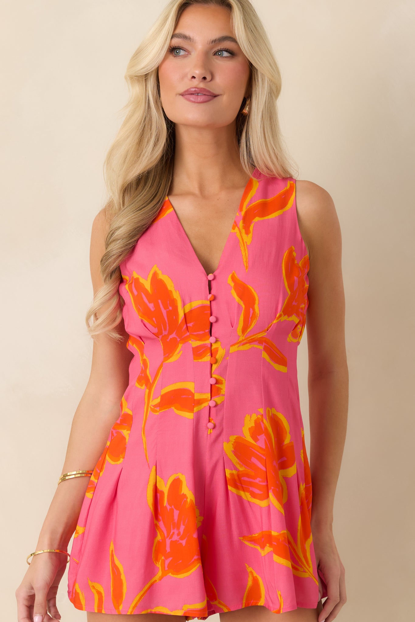 Cropped detail of tailored bodice flowing into relaxed flared shorts with side pockets.