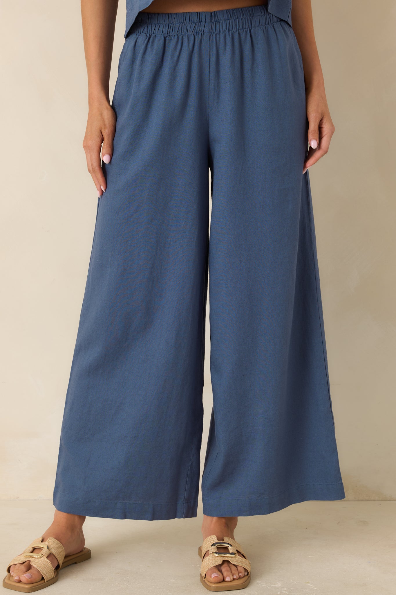 Cropped detail of lightweight linen blend fabric with flowing drape and side pocket design.