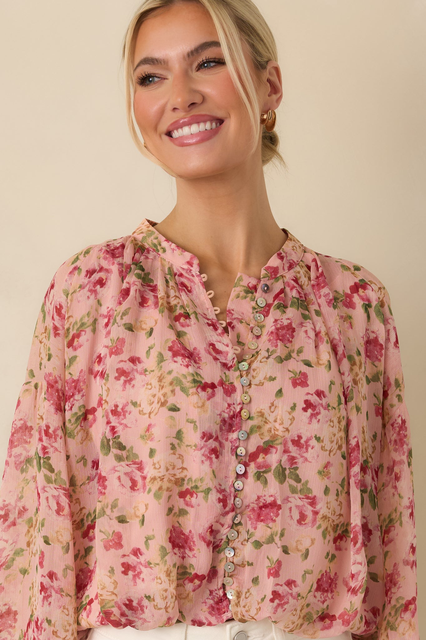 Cropped front view focusing on the abalone shell buttons and loop closures along the front.