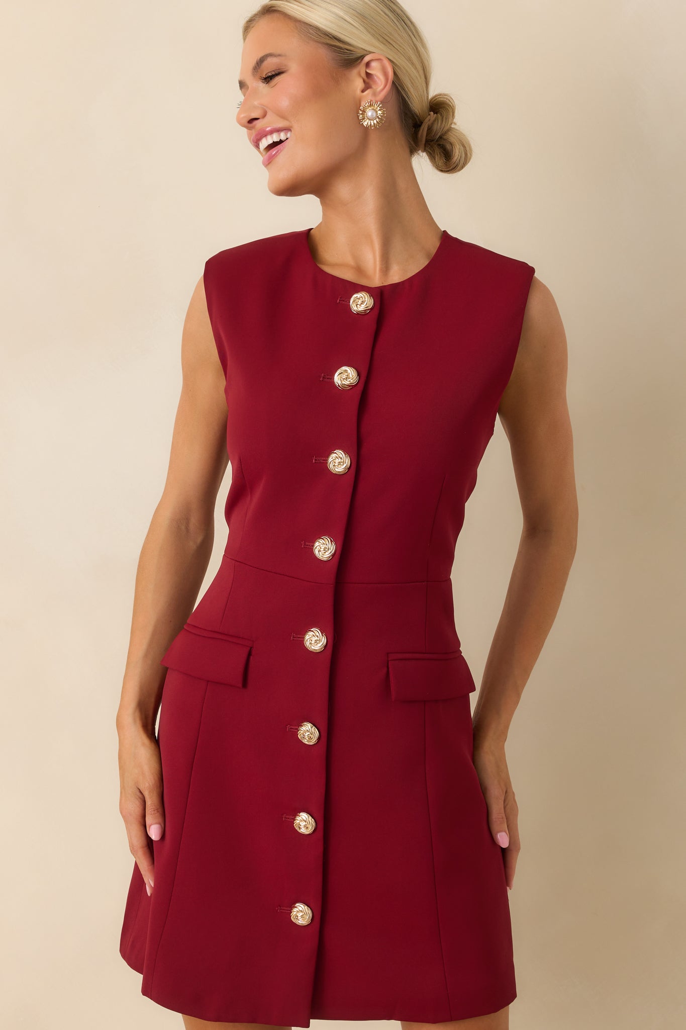 Cropped view focusing on the upper portion of the dress, showing the high neckline and top gold buttons.