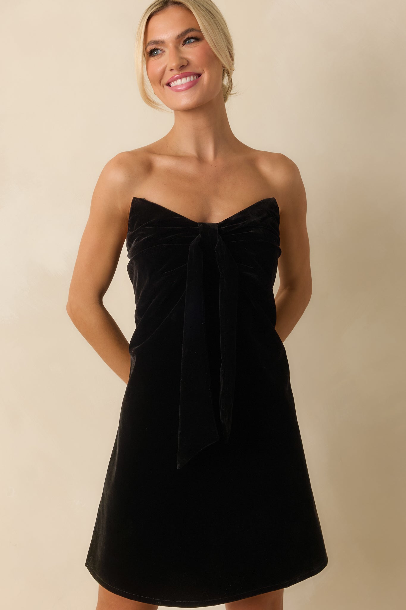 Cropped focus on the smooth fabric and defined A-line silhouette of the dress.