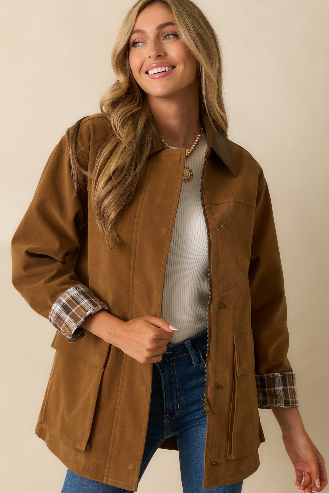 Cropped front photo showing the soft camel faux suede material and subtle texture.
