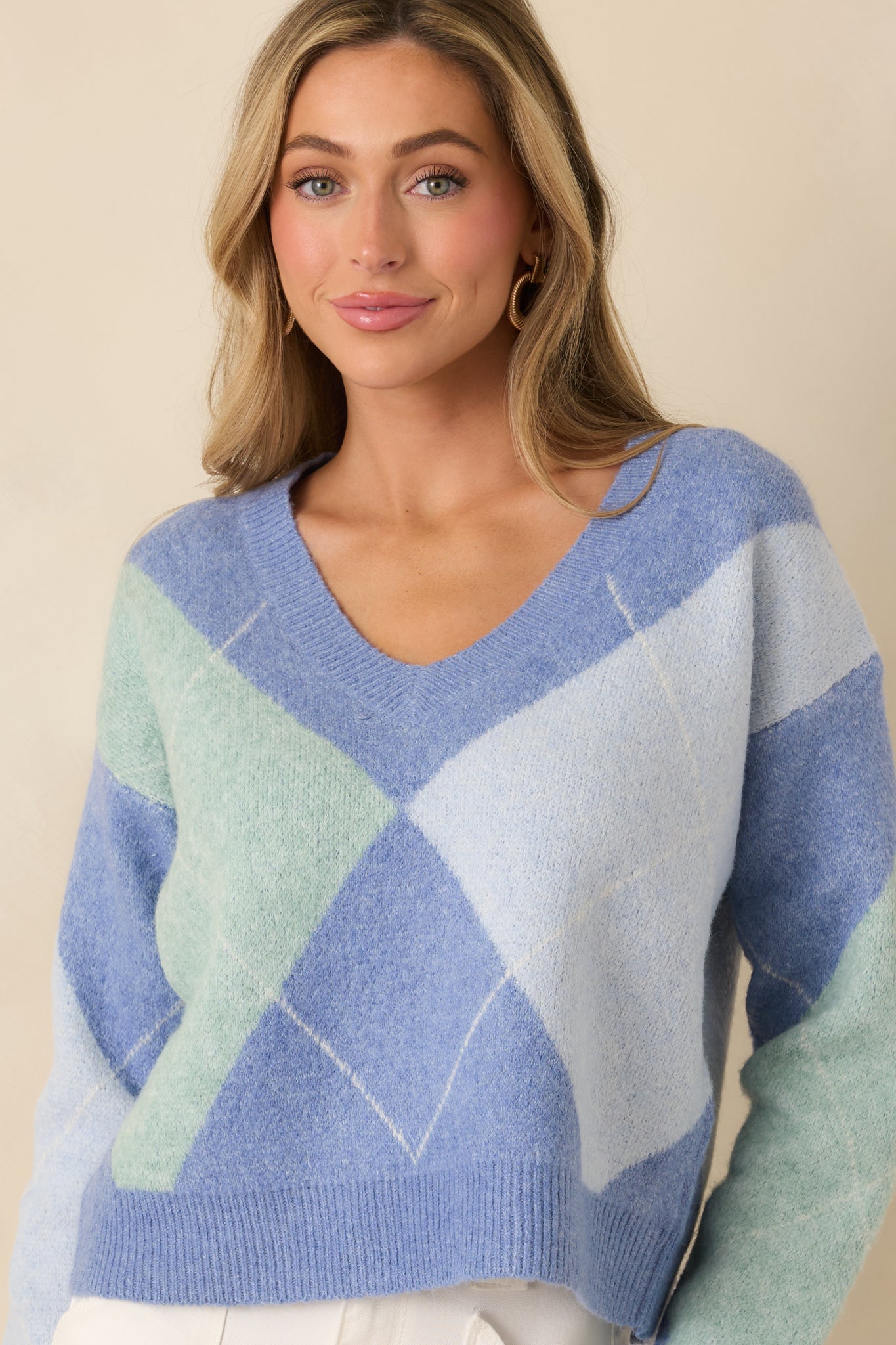 Front cropped view emphasizing the color-blocked argyle design and soft knit fabric.
