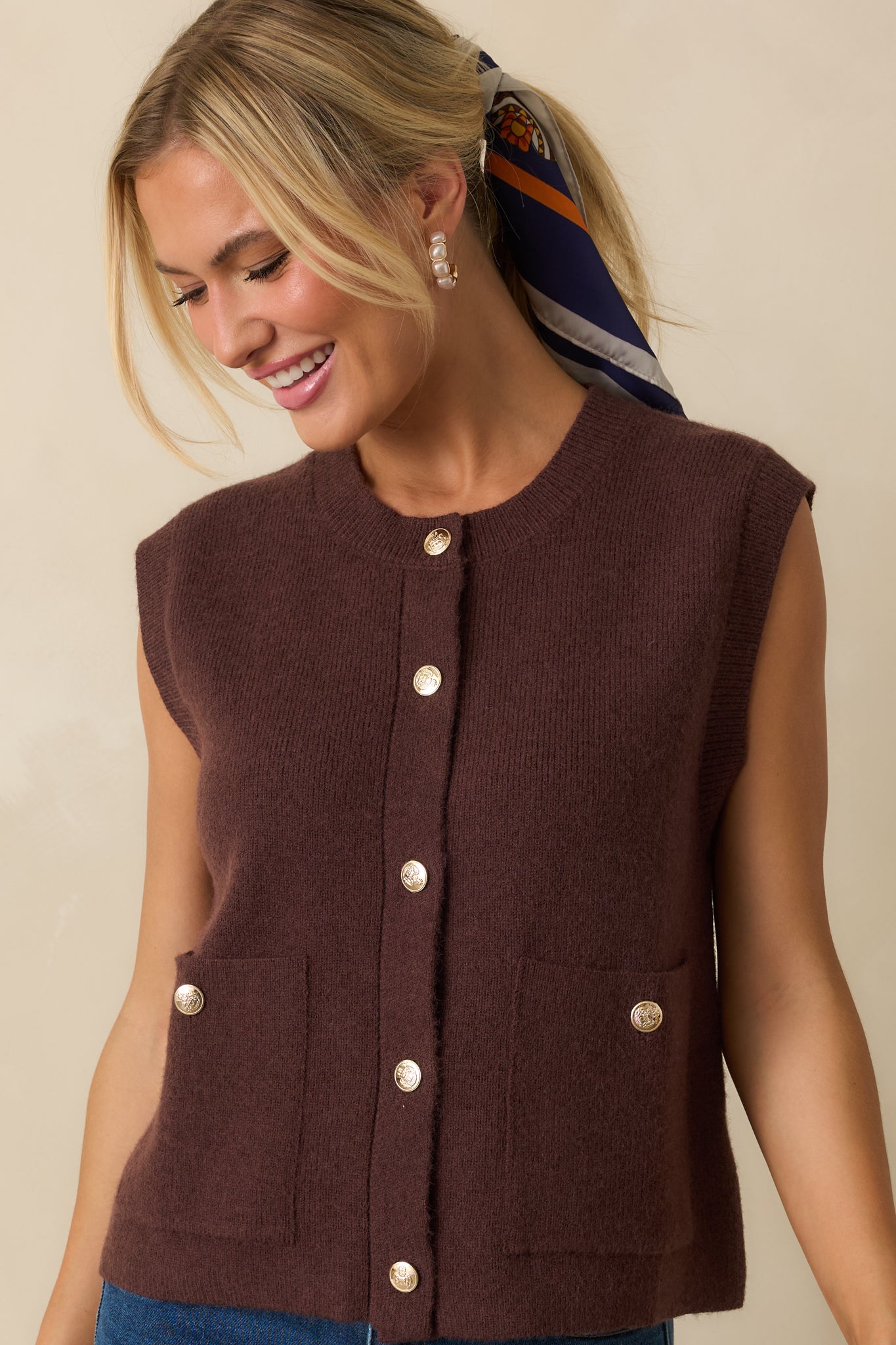 Cropped front view showing the knit texture and alignment of the button closures.