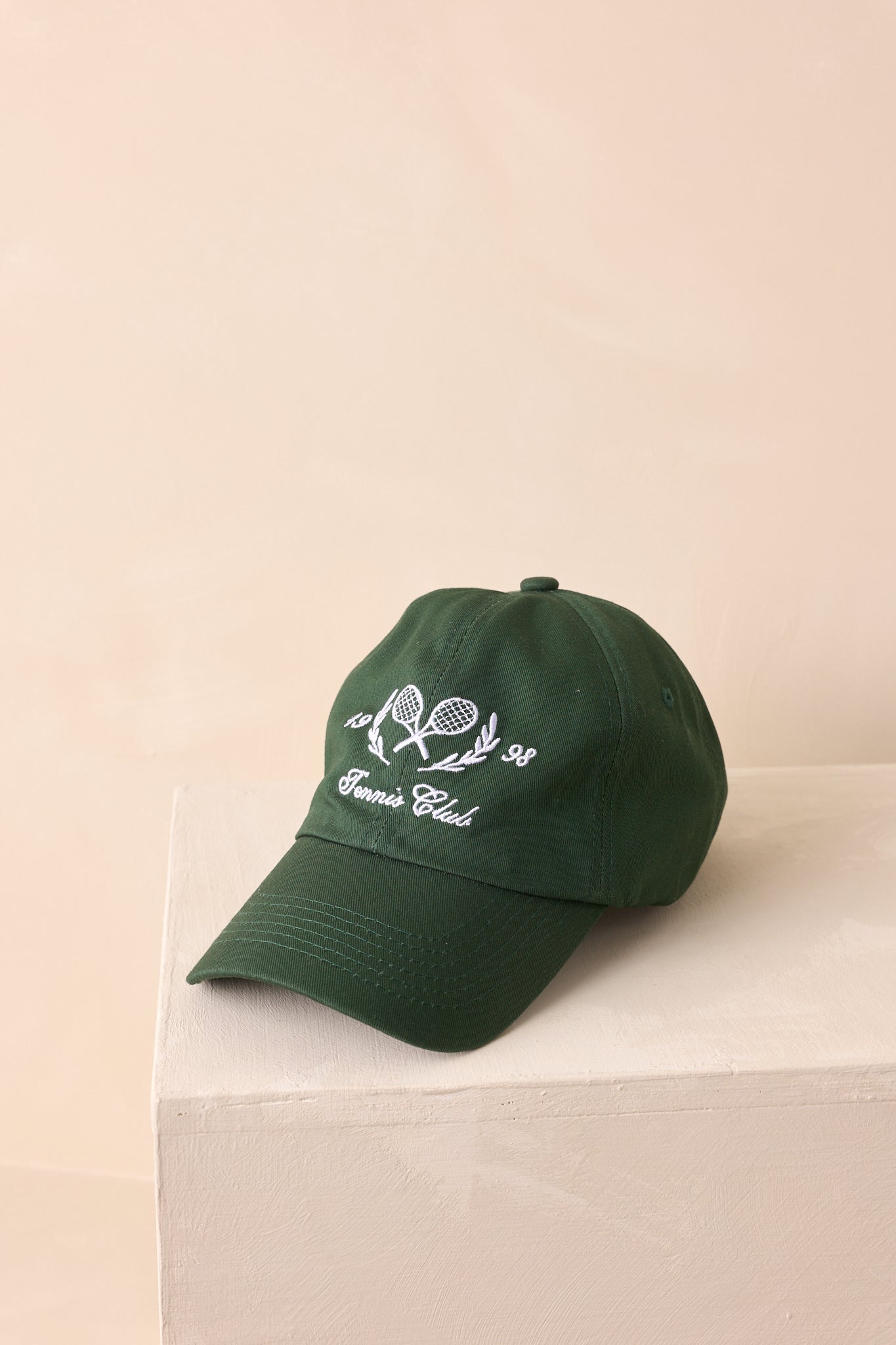 A cropped photo focusing on the structured front panels and detailed white embroidery design.