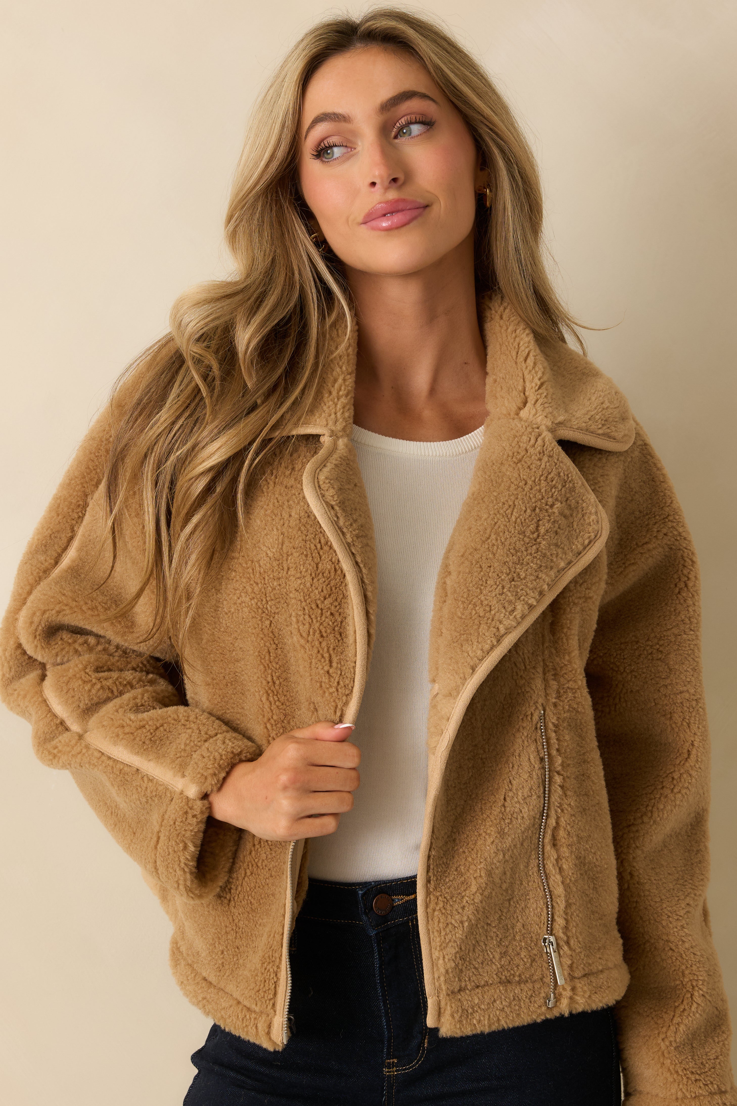 Cropped front view of the tan sherpa jacket focusing on the collared neckline and long sleeves.