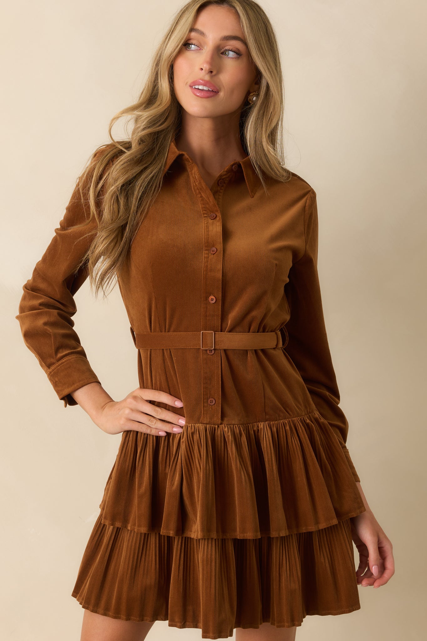 Cropped front view showing collared neckline and functional button-front details.