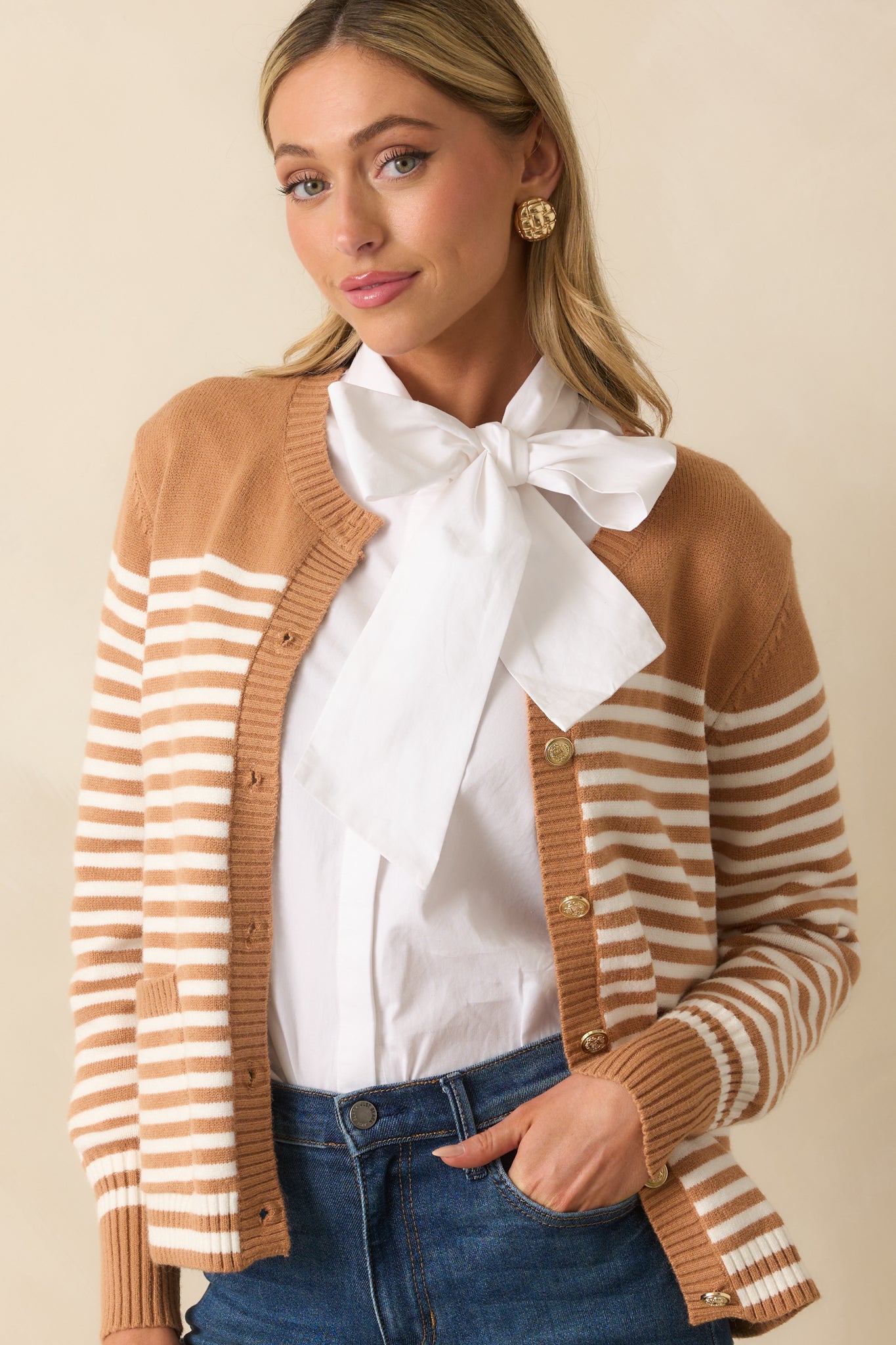 Cropped front view focusing on the embossed gold-tone buttons and ribbed hem details of the cardigan.