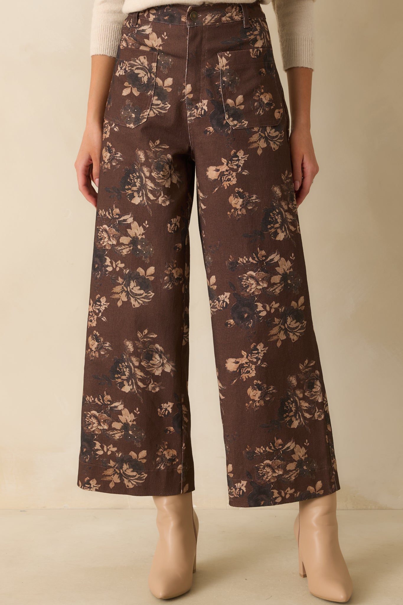 A cropped front view showing the floral print detail with functional front patch pockets and waistband.