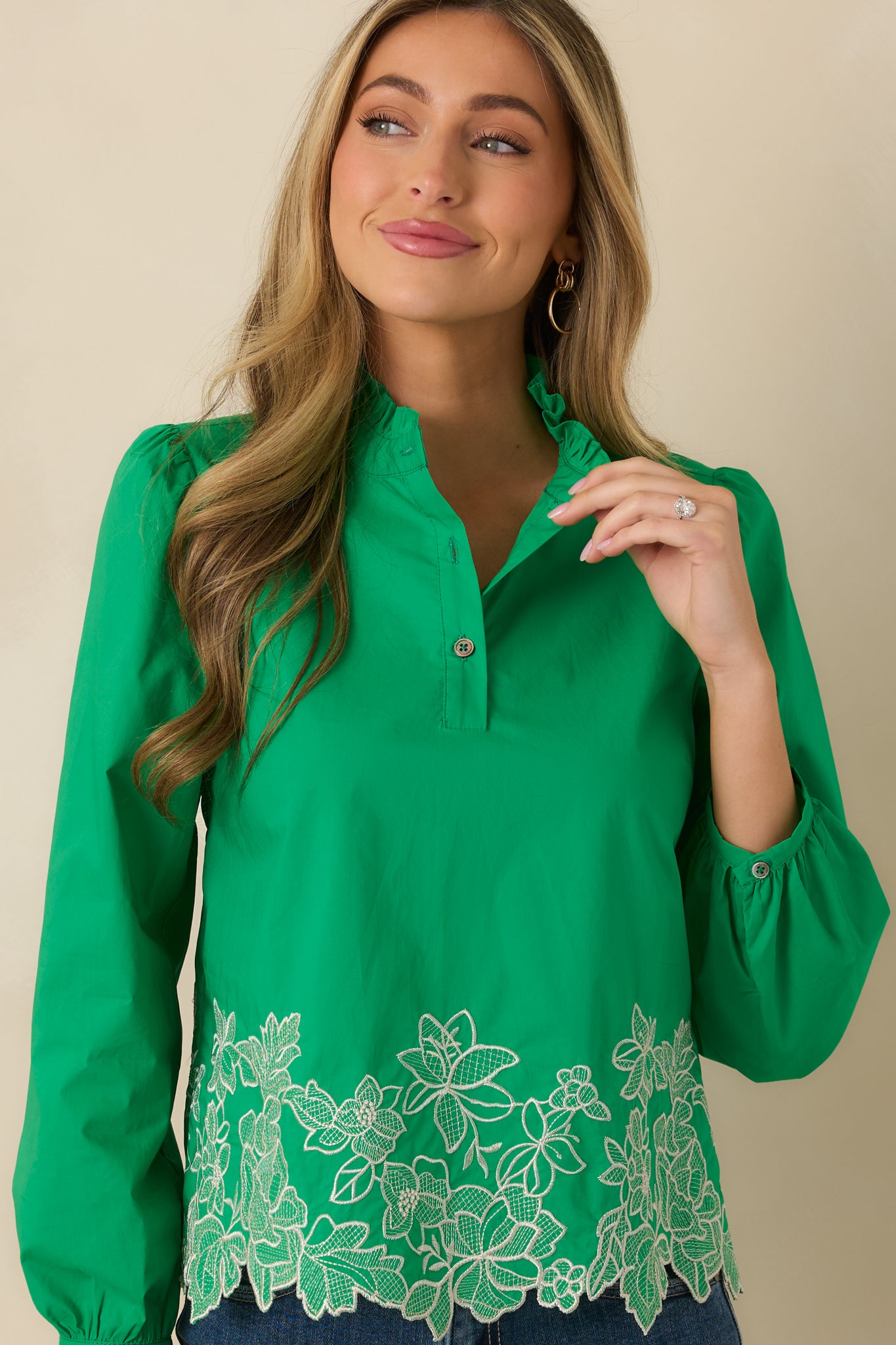 Cropped front view of the green top emphasizing the gathered neckline and partial button-front placket.