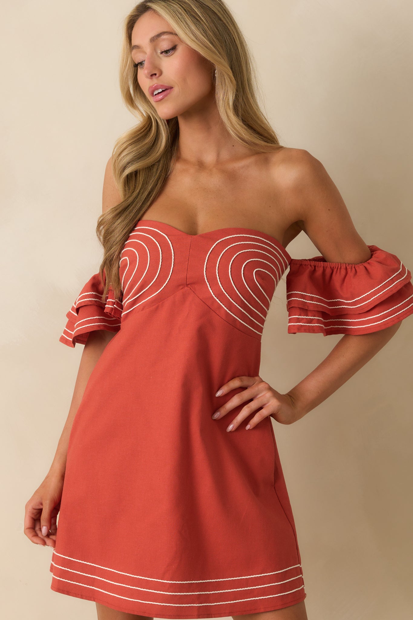 A cropped front view highlighting the flutter sleeves worn off the shoulder.