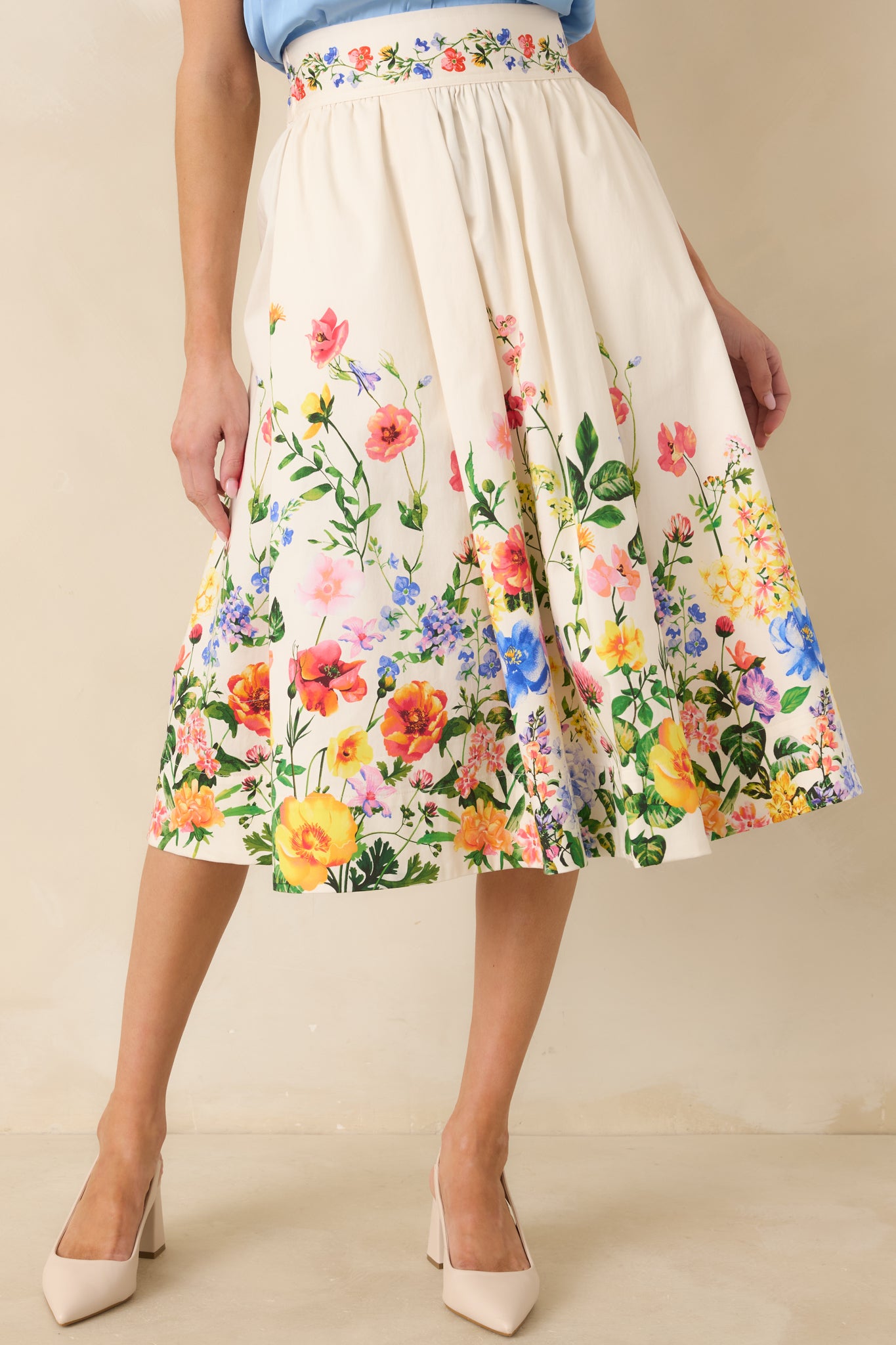 Cropped front view of the ivory midi skirt emphasizing the elasticized waistband and smooth cotton satin texture.