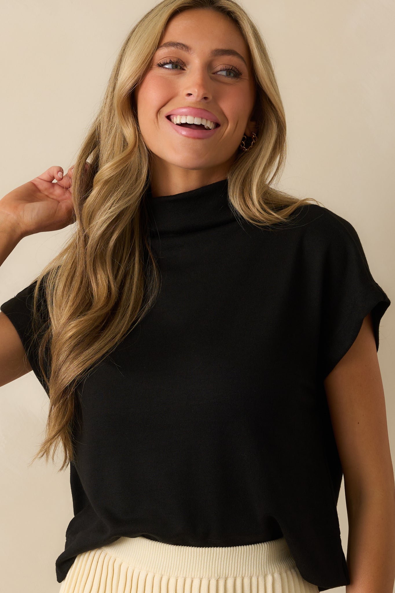 A cropped front view focusing on the roll mock neckline and cap sleeve detail.