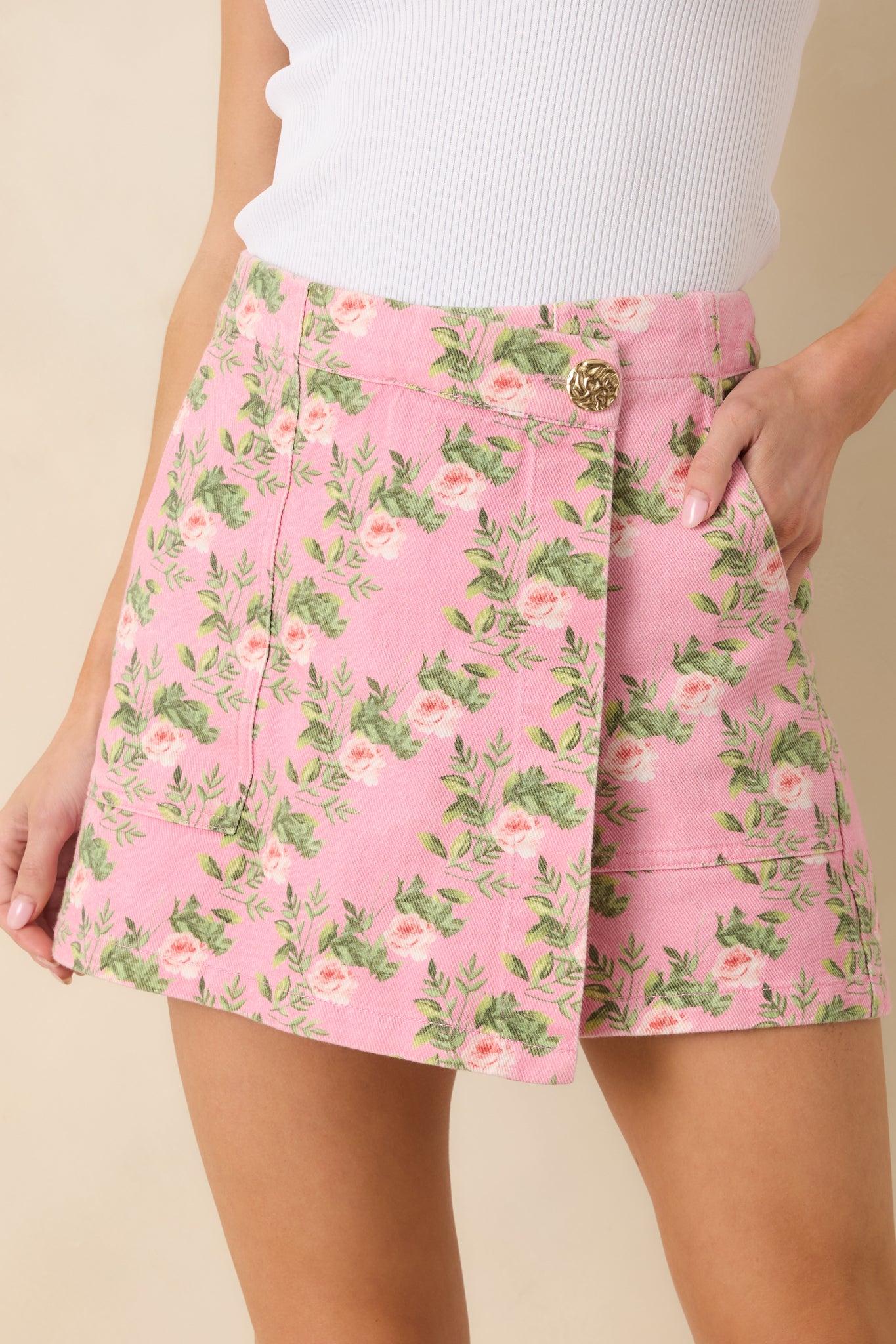 Cropped front view focusing on the waistband with gold button and silver zipper details.
