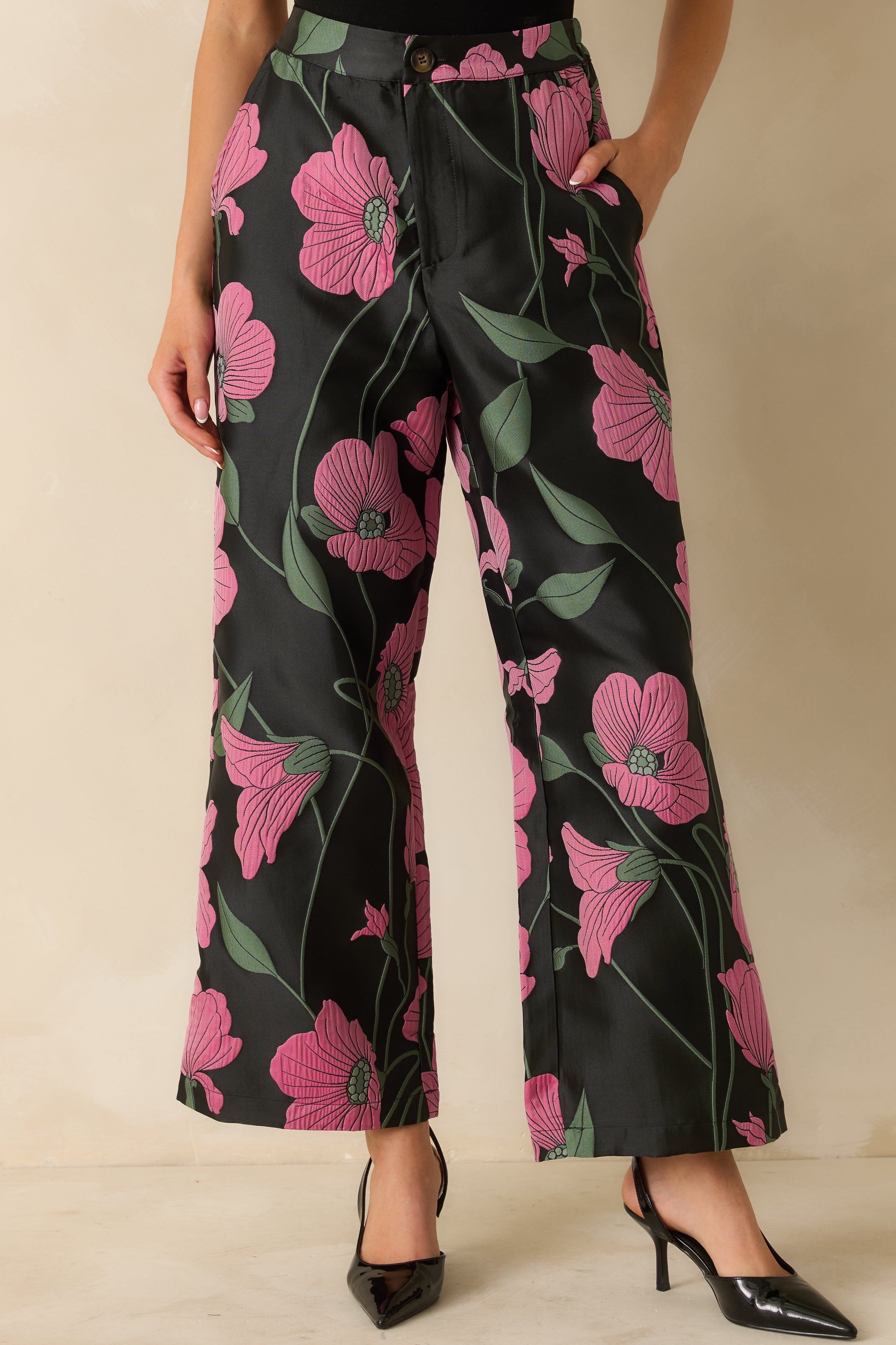 Cropped front view focusing on the floral pattern and button zipper closure at the high waist.