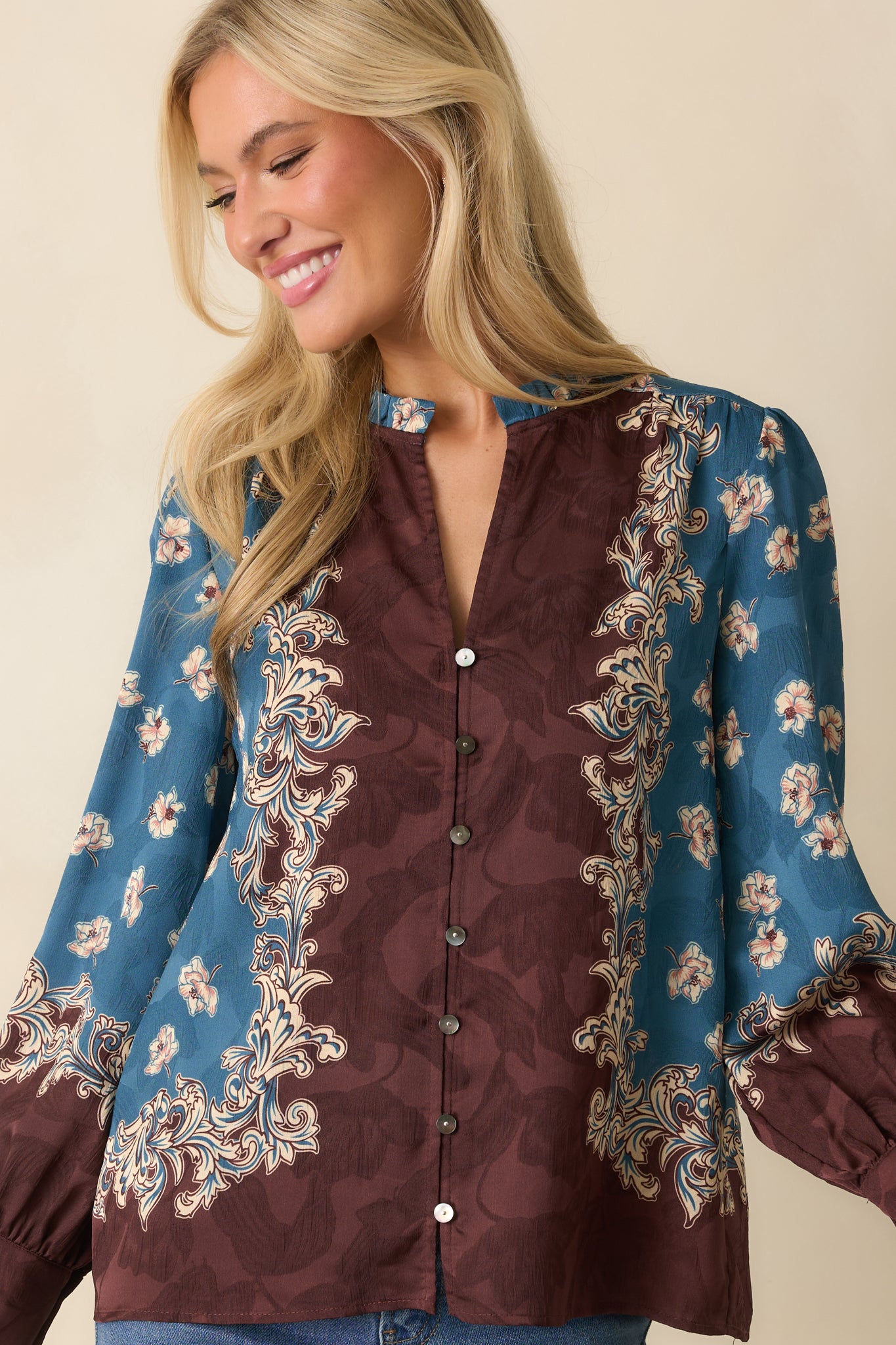 A cropped image emphasizing the fabric texture and floral border along the blouse hem.