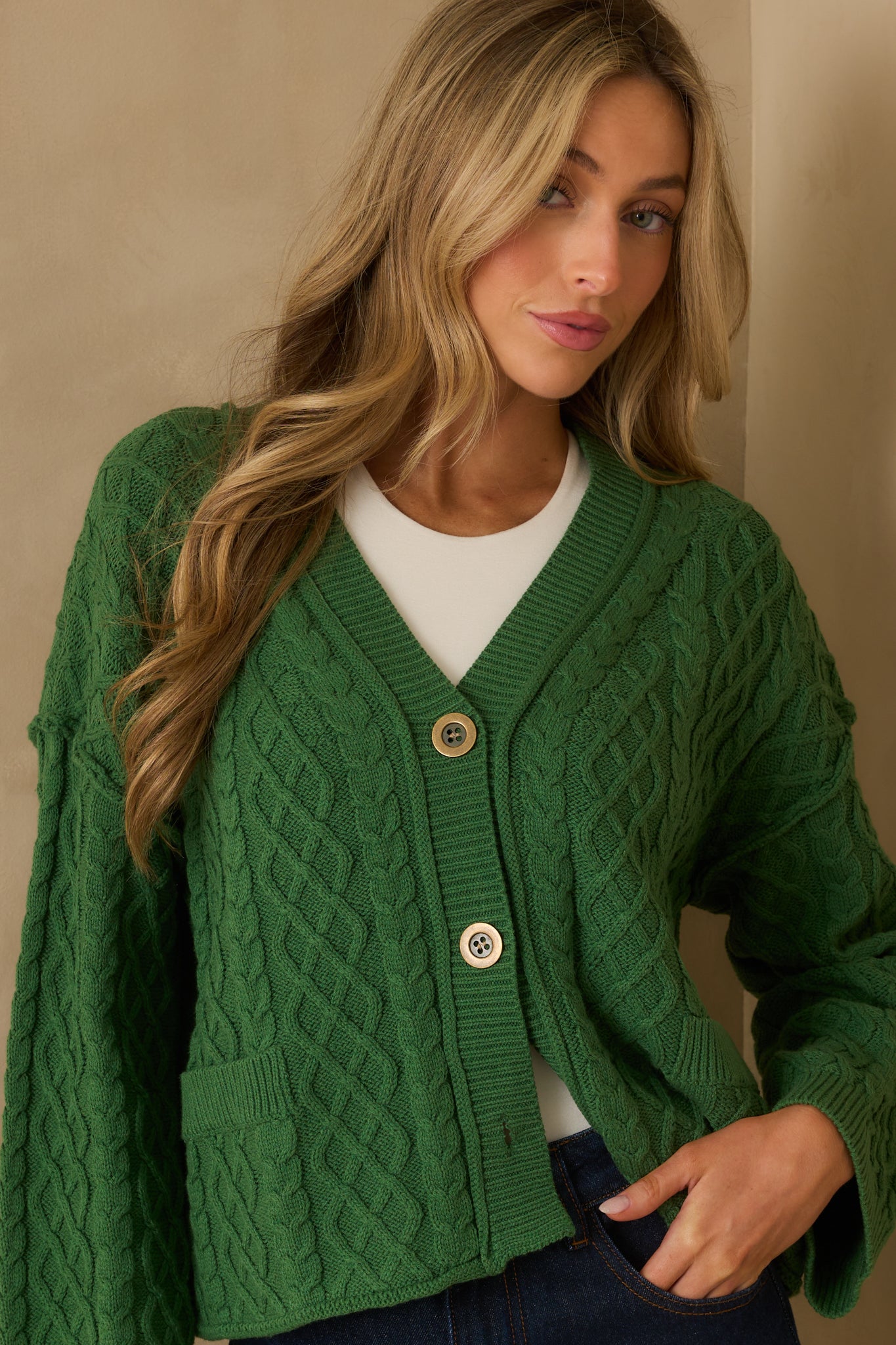 Cropped image highlighting one of the faux front patch pockets and surrounding knit texture.