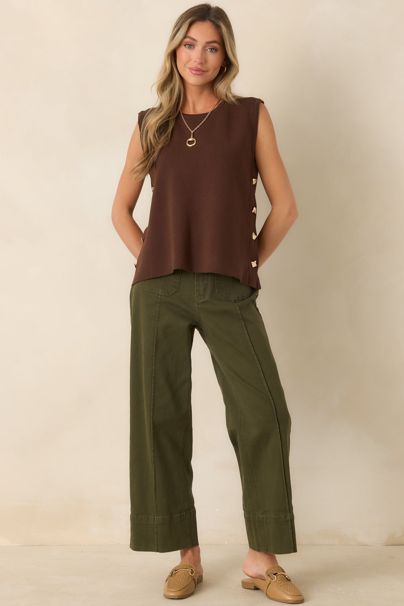 Cropped wide-leg pants showcasing a rich olive hue, structured seams, oversized pockets, and a versatile everyday design.