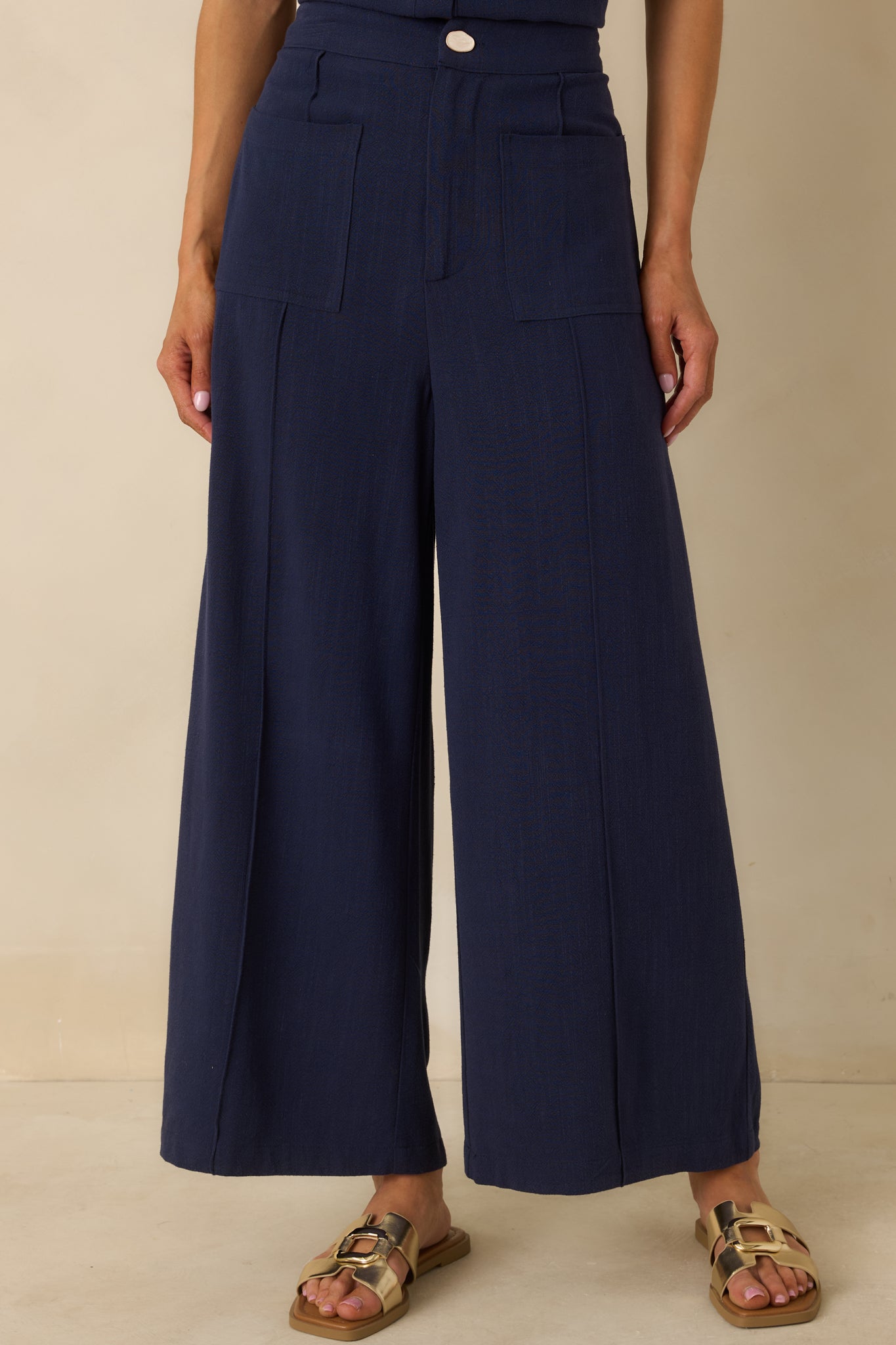 Cropped perspective emphasizing the clean lines and fluid movement of the wide leg silhouette.