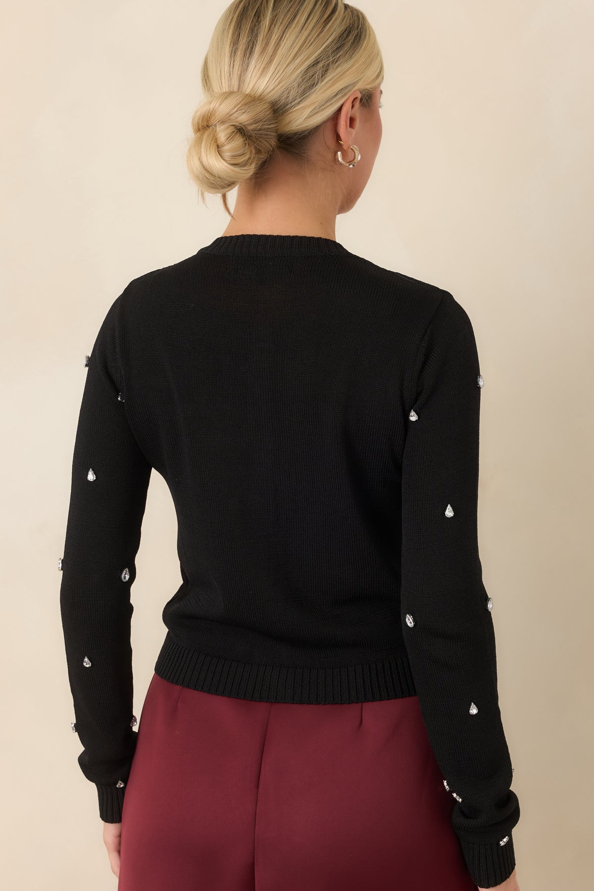 Rear of the cropped cardigan showing the neat silhouette and ribbed hem and cuffs.