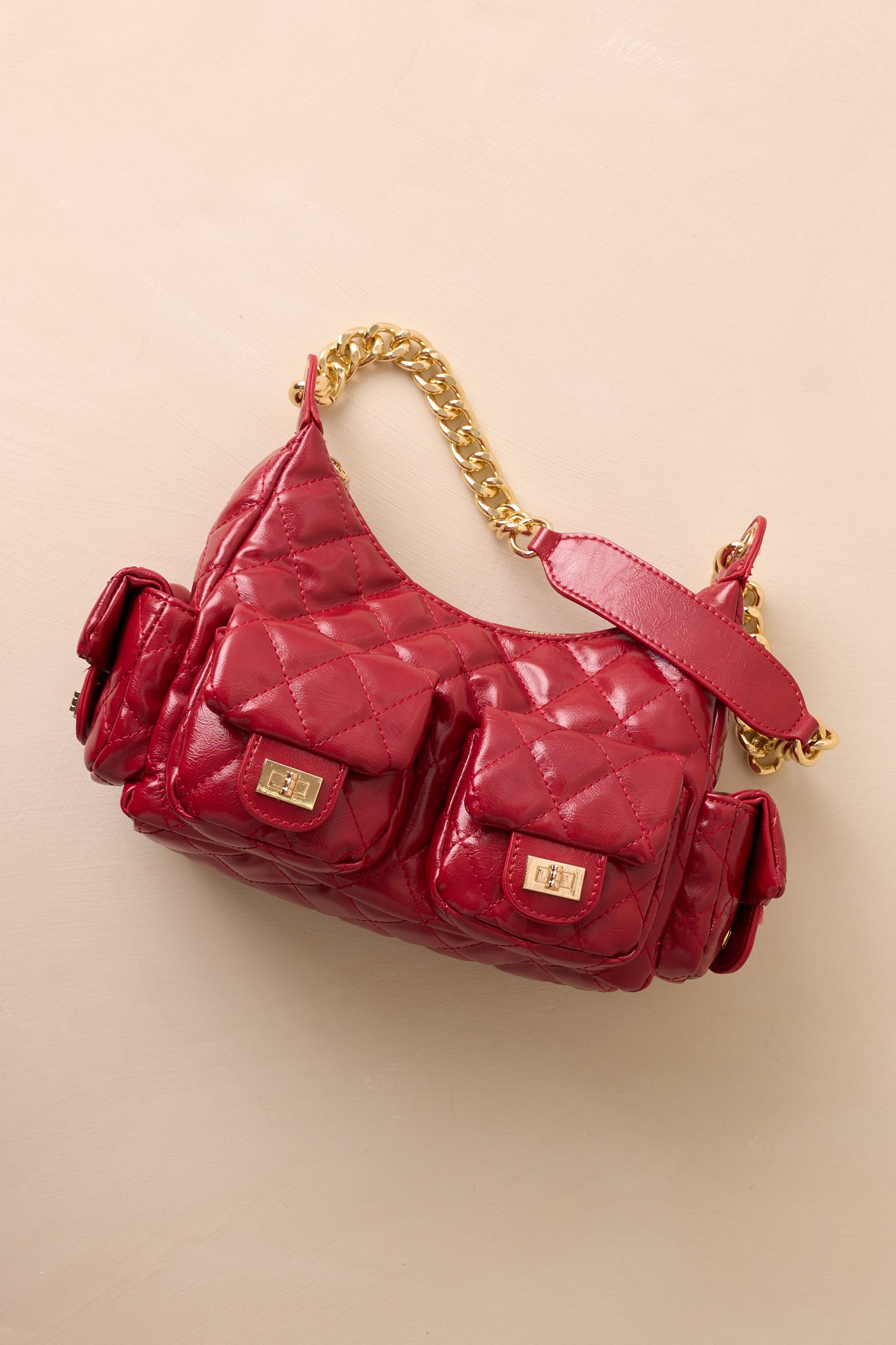 A cropped angled shot of the handbag focusing on the quilted faux leather texture and gold chain detail.