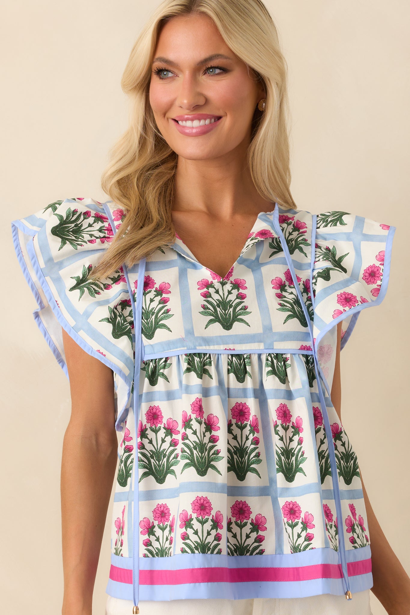 Cropped shot emphasizing the hem and lower portion of the top, capturing the relaxed silhouette and printed pattern.