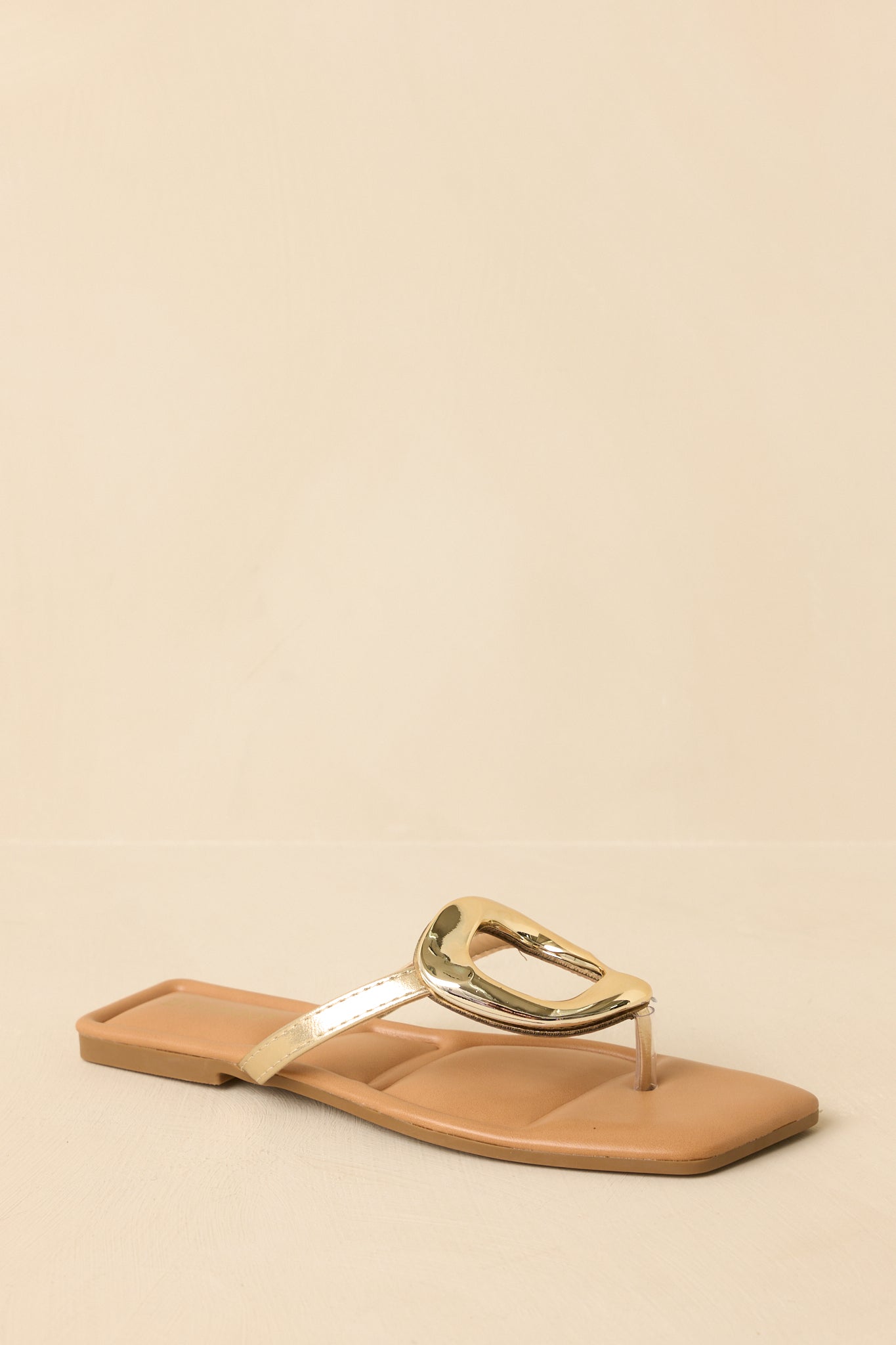 Detailed cropped shot of the metallic thong sandals showcasing the slip-on design and cushioned footbed.