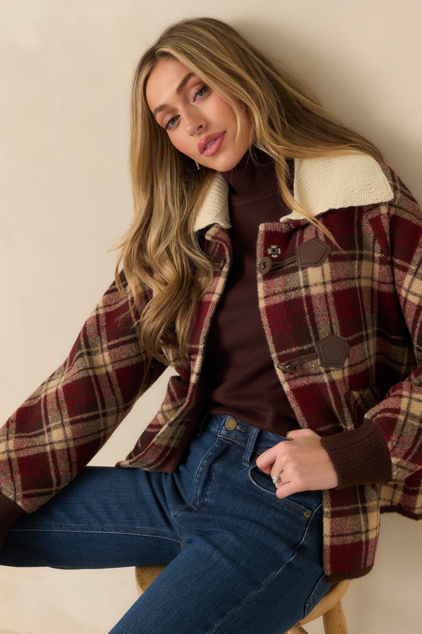 Cropped angled shot showing pocket openings, ribbed cuffs, and textured plaid material.