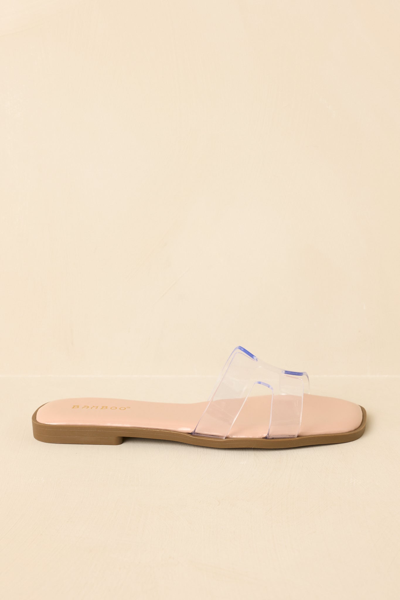 Cropped side view emphasizing flat sole and easy slip-on design.