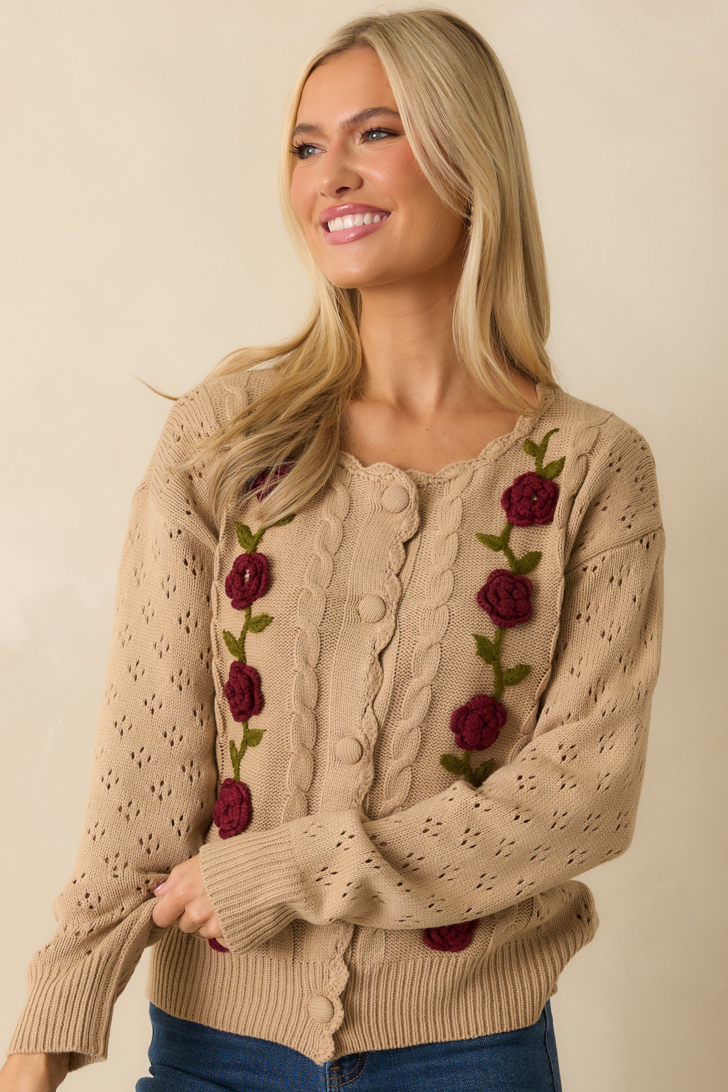 Cropped sleeve detail showing the openwork knit pattern and long sleeve structure.