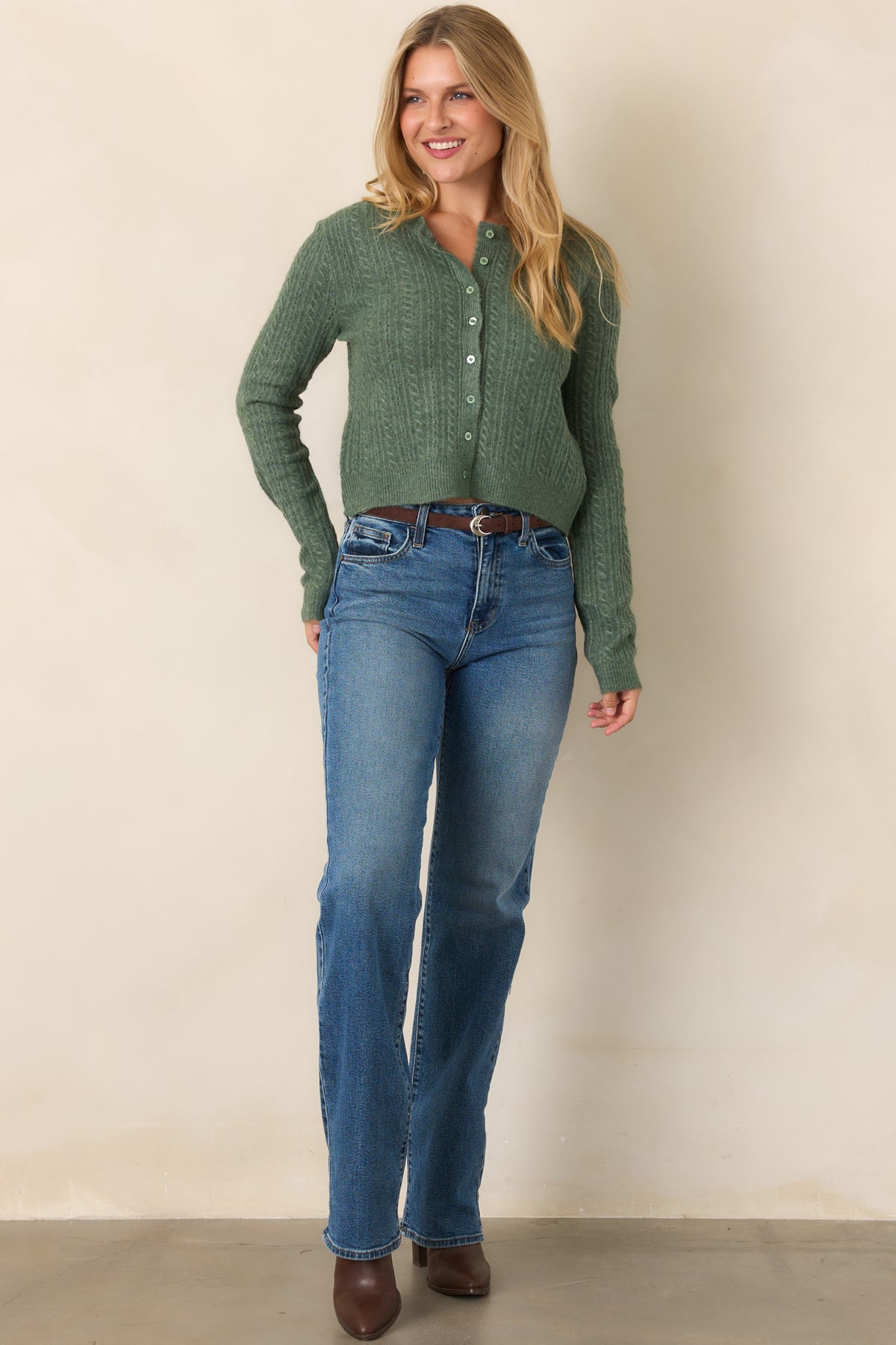 Slightly cropped button-front cardigan crafted from soft stretch knit, with long sleeves, a round neckline, and ribbed cuffs and hem.