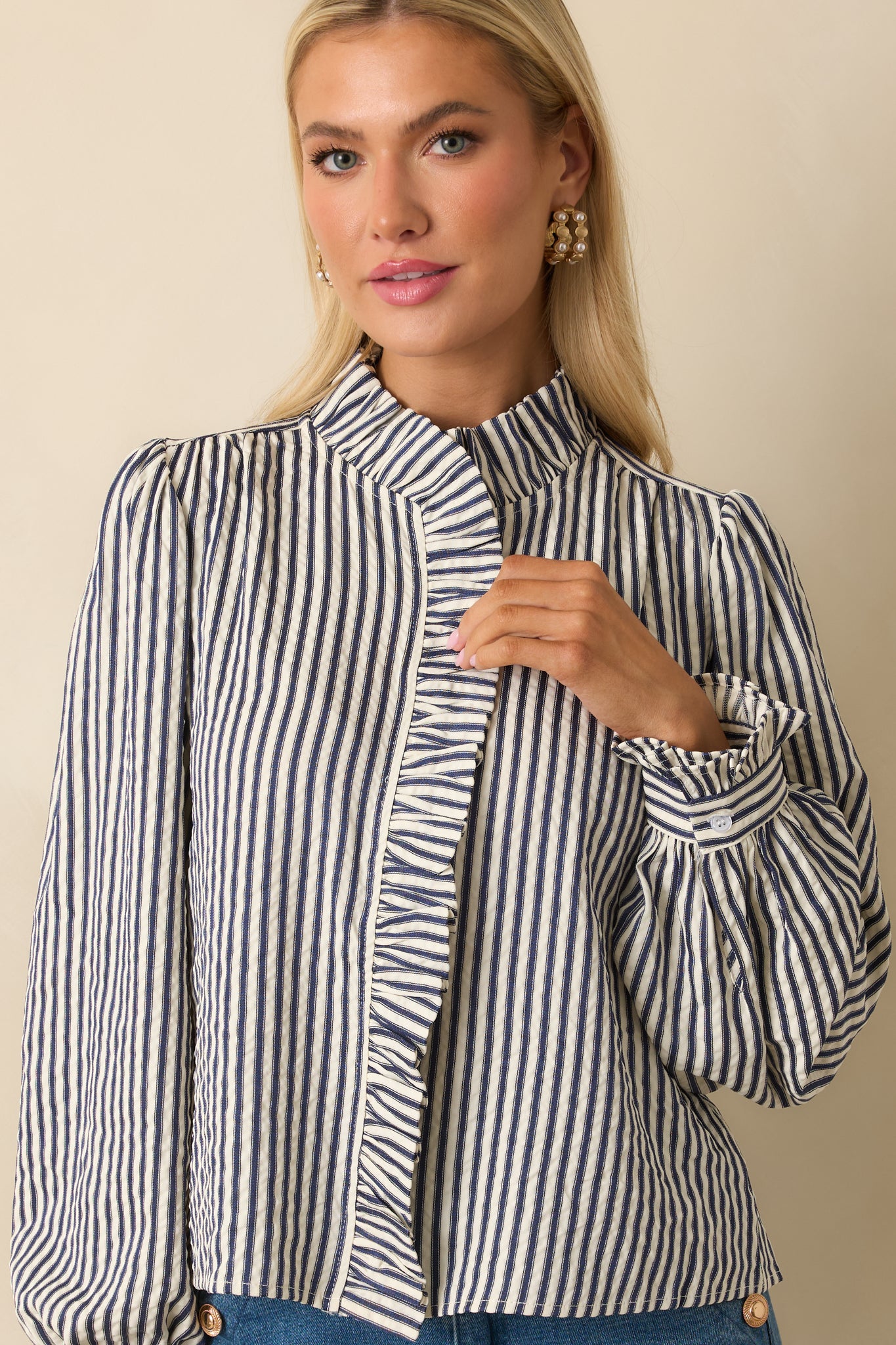 Cropped view showcasing fine stripe detailing across the front and gathered cuffs.
