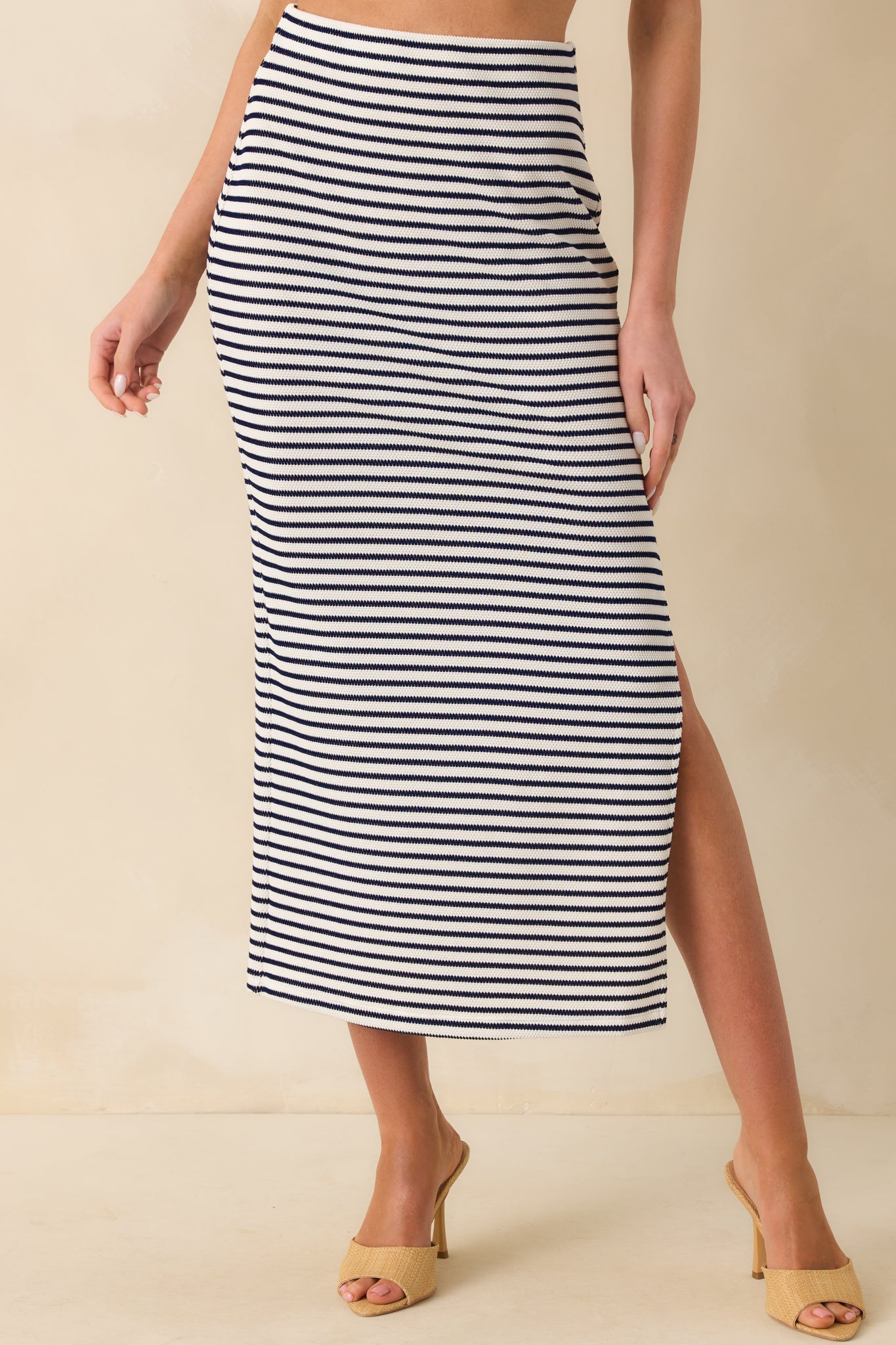 A cropped front view focusing on the mid-rise elastic waistband and the consistent navy and white stripe design.