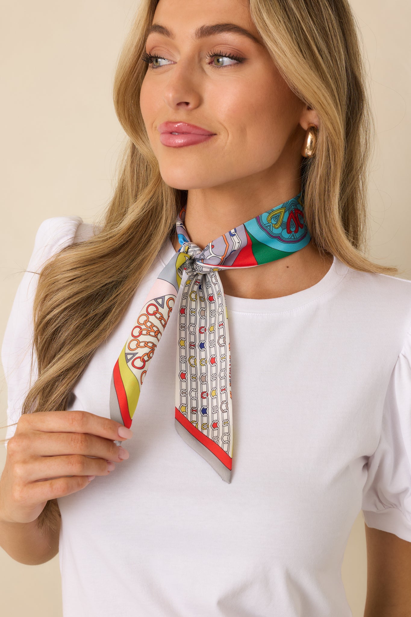 Cropped view highlighting the abstract chain pattern along the multicolor scarf tie.